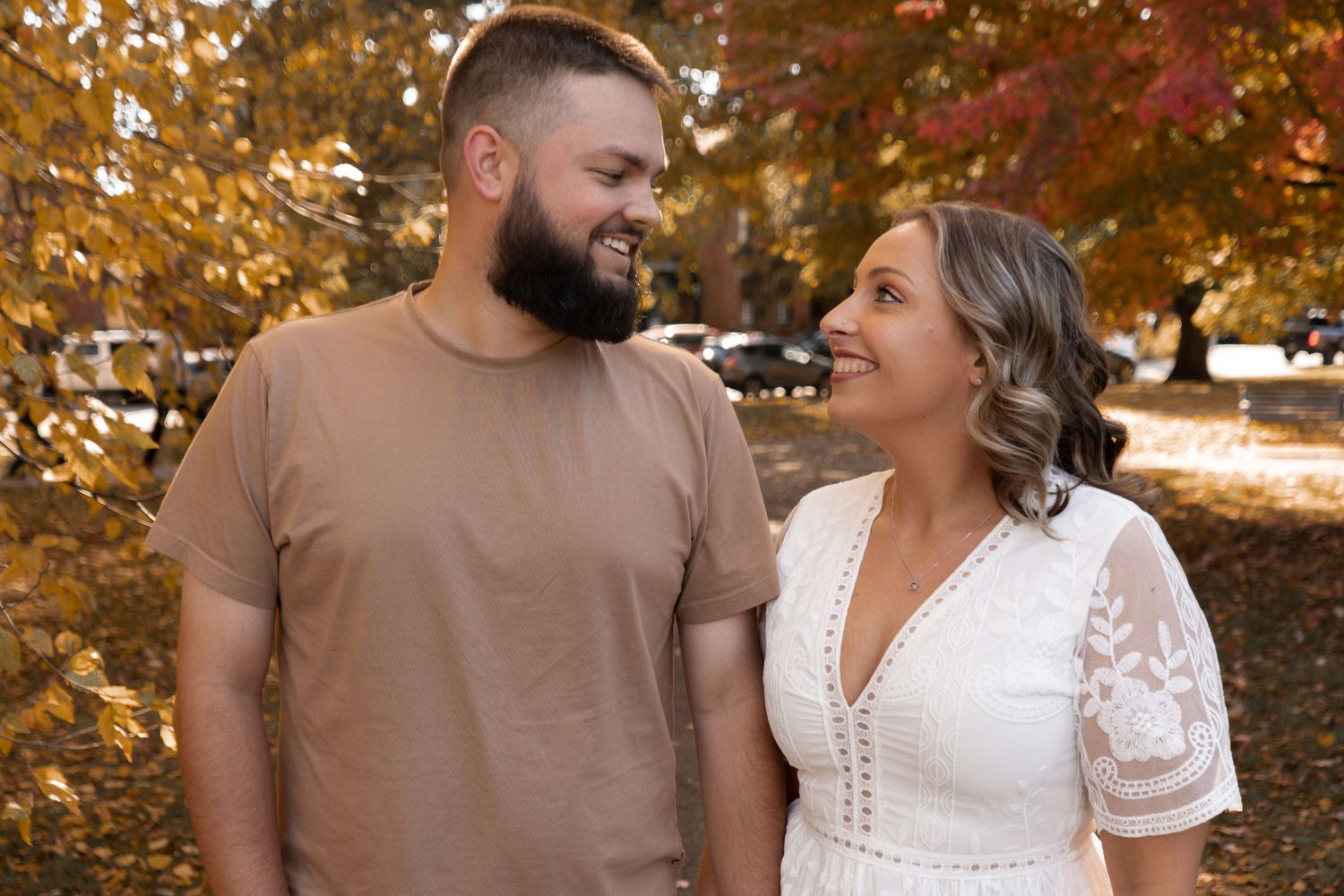 A couple sharing intimate moments during an autumn photoshoot.