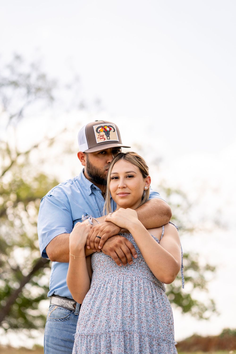Intimate outdoor portrait session in natural light with soft focus background.