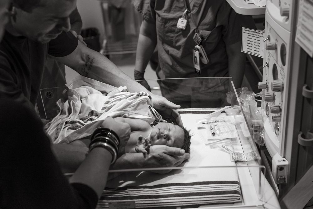 Medical professionals monitor patient data on hospital equipment and screens showing vital signs.