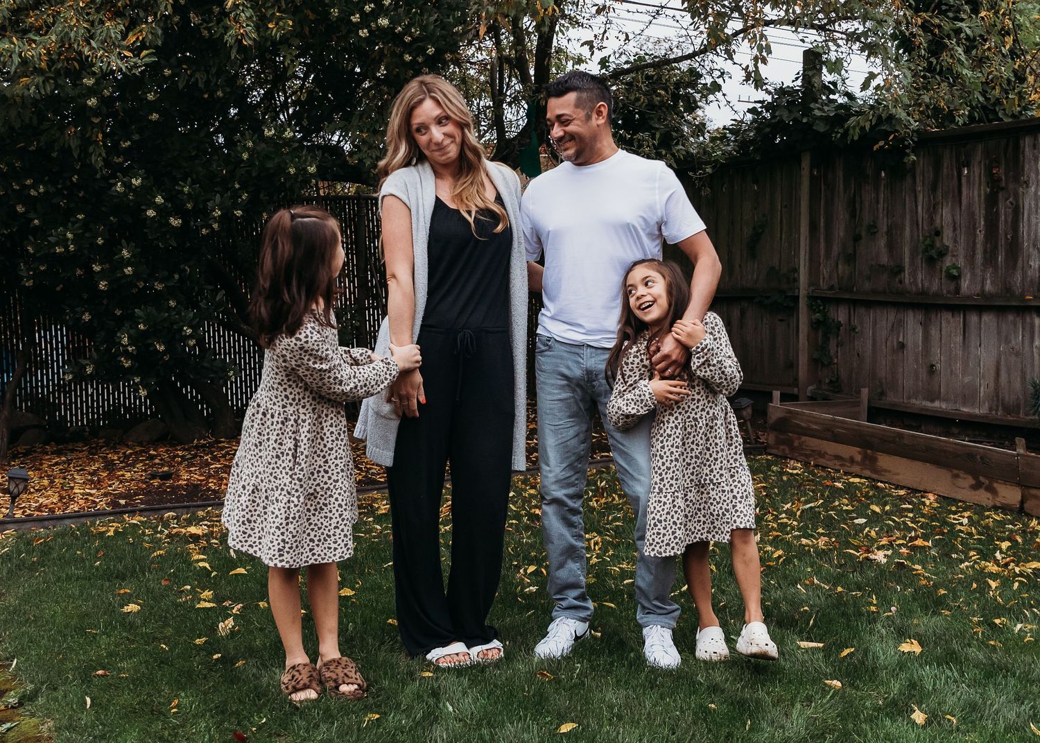 Candid outdoor photo sequence showing loving family moments in a backyard with fall leaves on the ground.