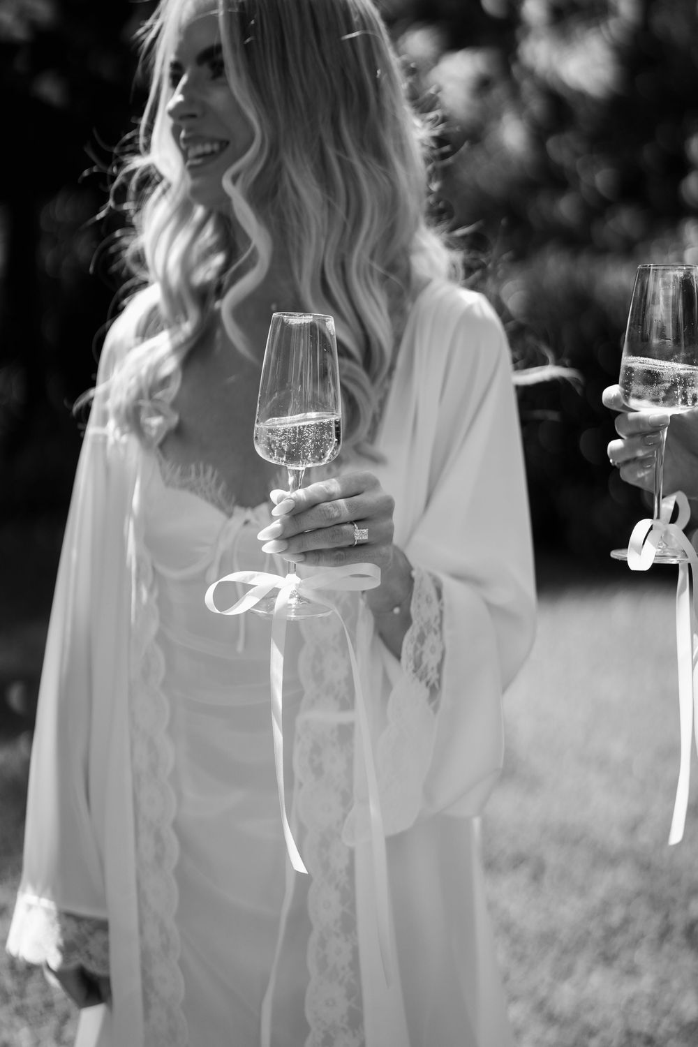 Series of dreamy black and white photographs showing someone in white holding a glass in an outdoor garden setting.