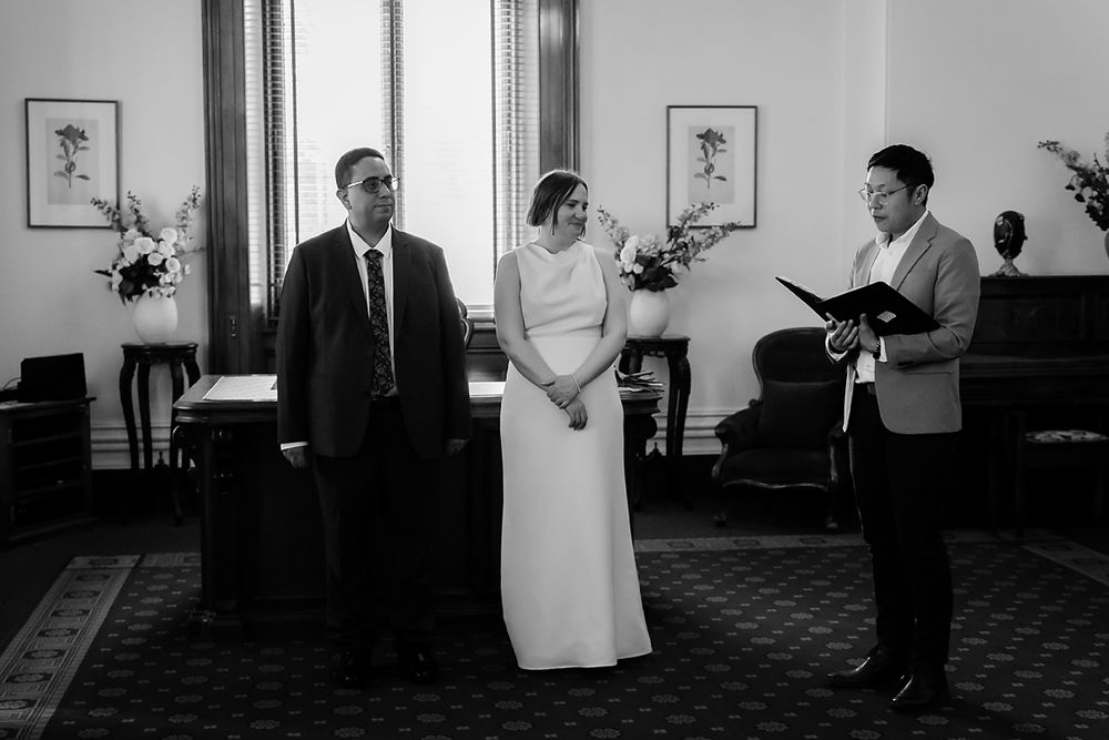 A sequence of five black and white photos showing different moments at a wedding reception.