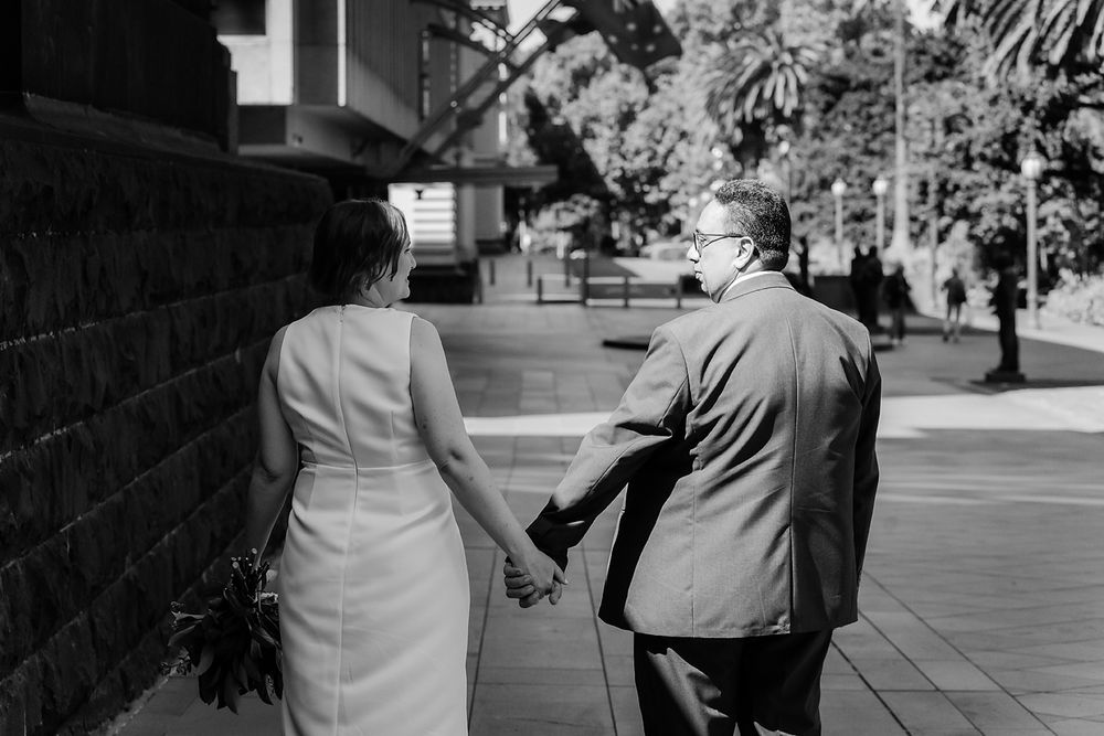People walking together outside in a series of vintage analog style black and white photographs.