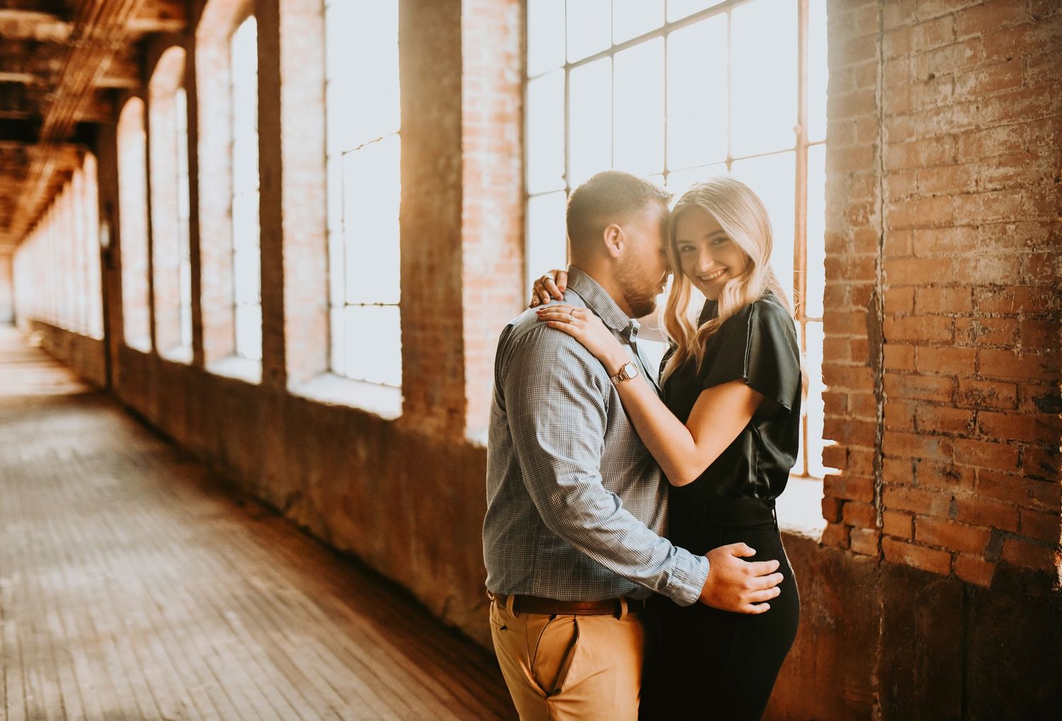 Natural candid laughter during proposal photos at McKinney Cotton Mill