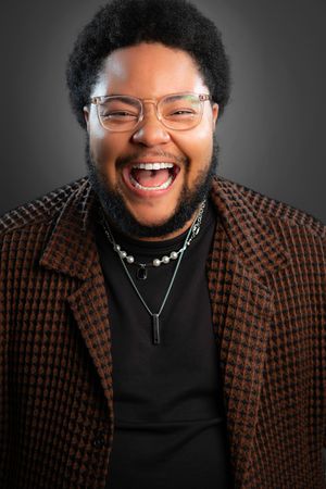 A series of expressive portraits showing genuine joy and laughter while wearing a brown patterned blazer and black shirt.