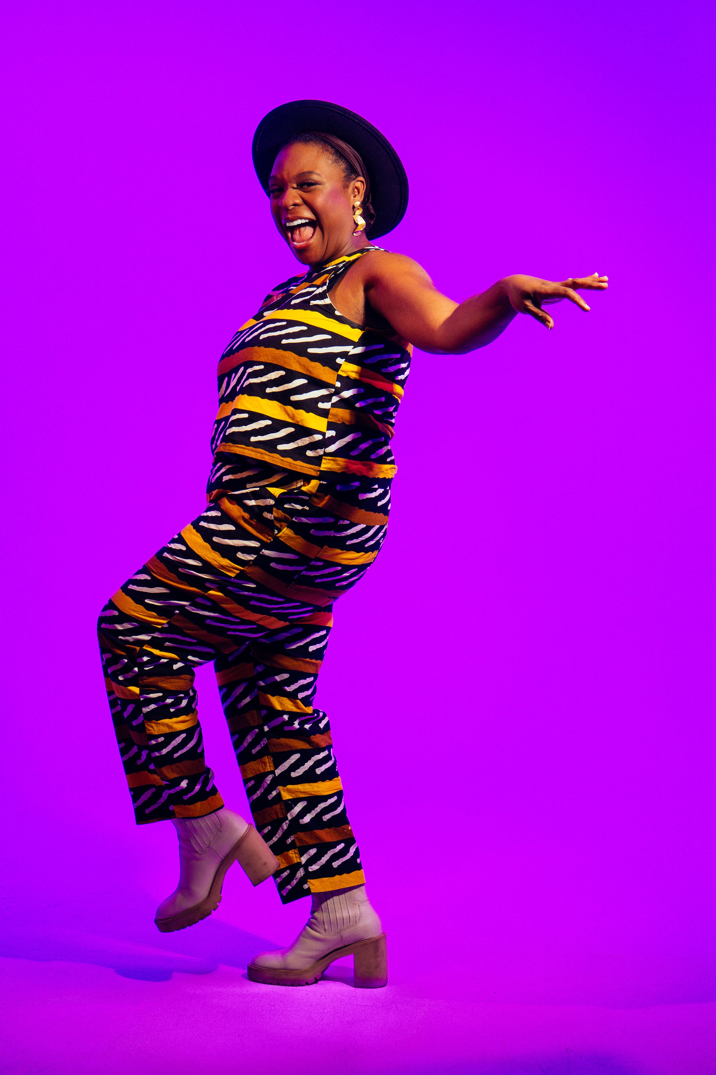 Person in tiger-striped jumpsuit dances expressively against vibrant purple background in sequential motion capture.