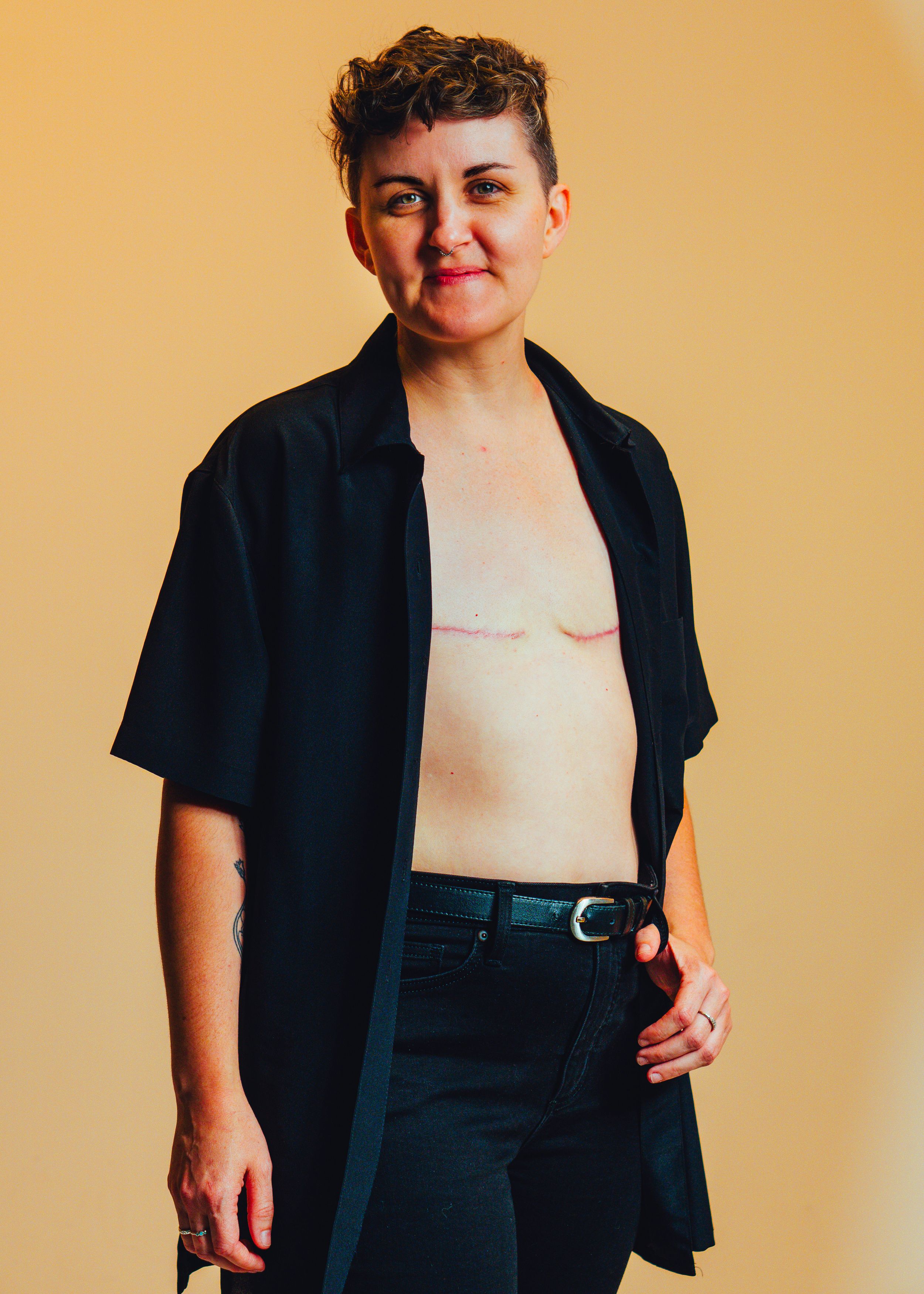 A series of fashion photos showing someone wearing a black blazer with white top and dark pants against a beige background.