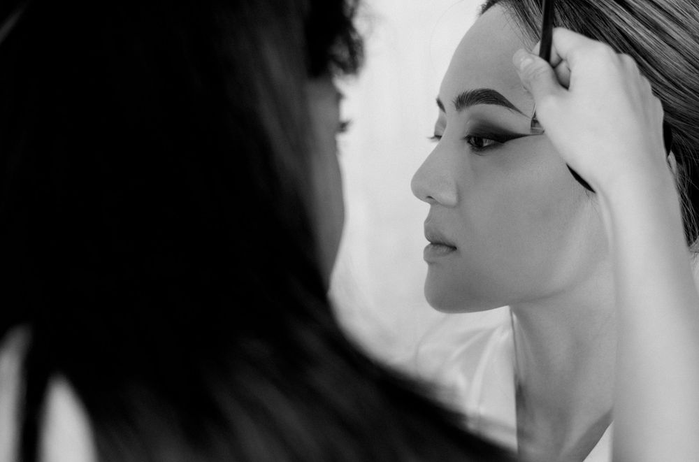 Artistic black and white profile shots capturing bridal beauty preparations.