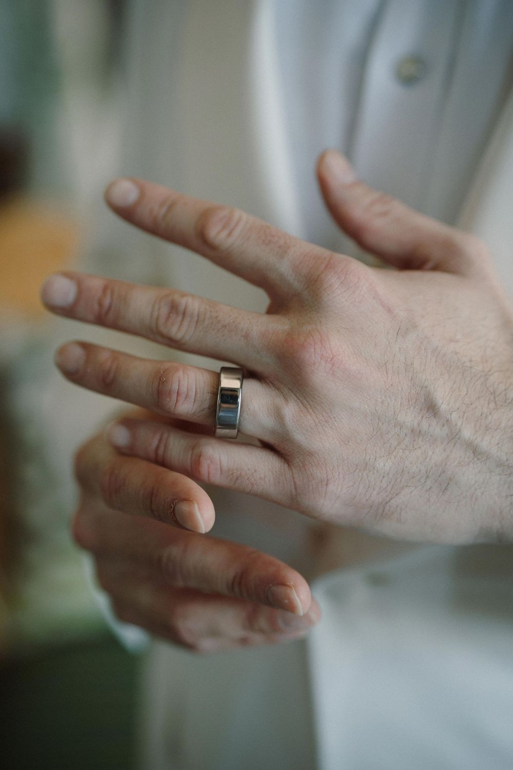 Close-up sequence of hands showing wedding ring being removed from finger in multiple steps.