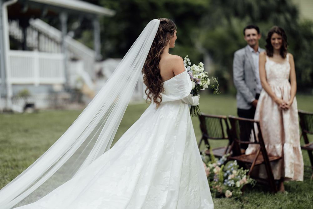 Six ethereal bridal photographs show flowing white dresses and romantic wedding moments in an outdoor garden setting.