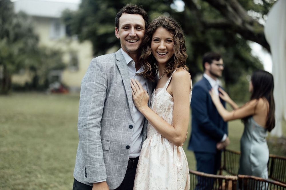 Happy couple shares joyful moments during their outdoor wedding celebration.