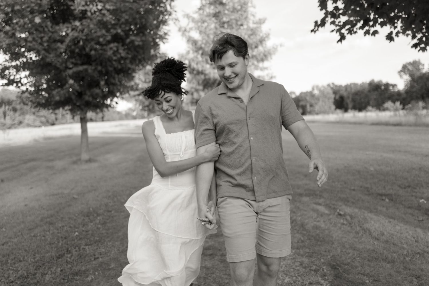 A couple shares a tender embrace in a natural outdoor setting.