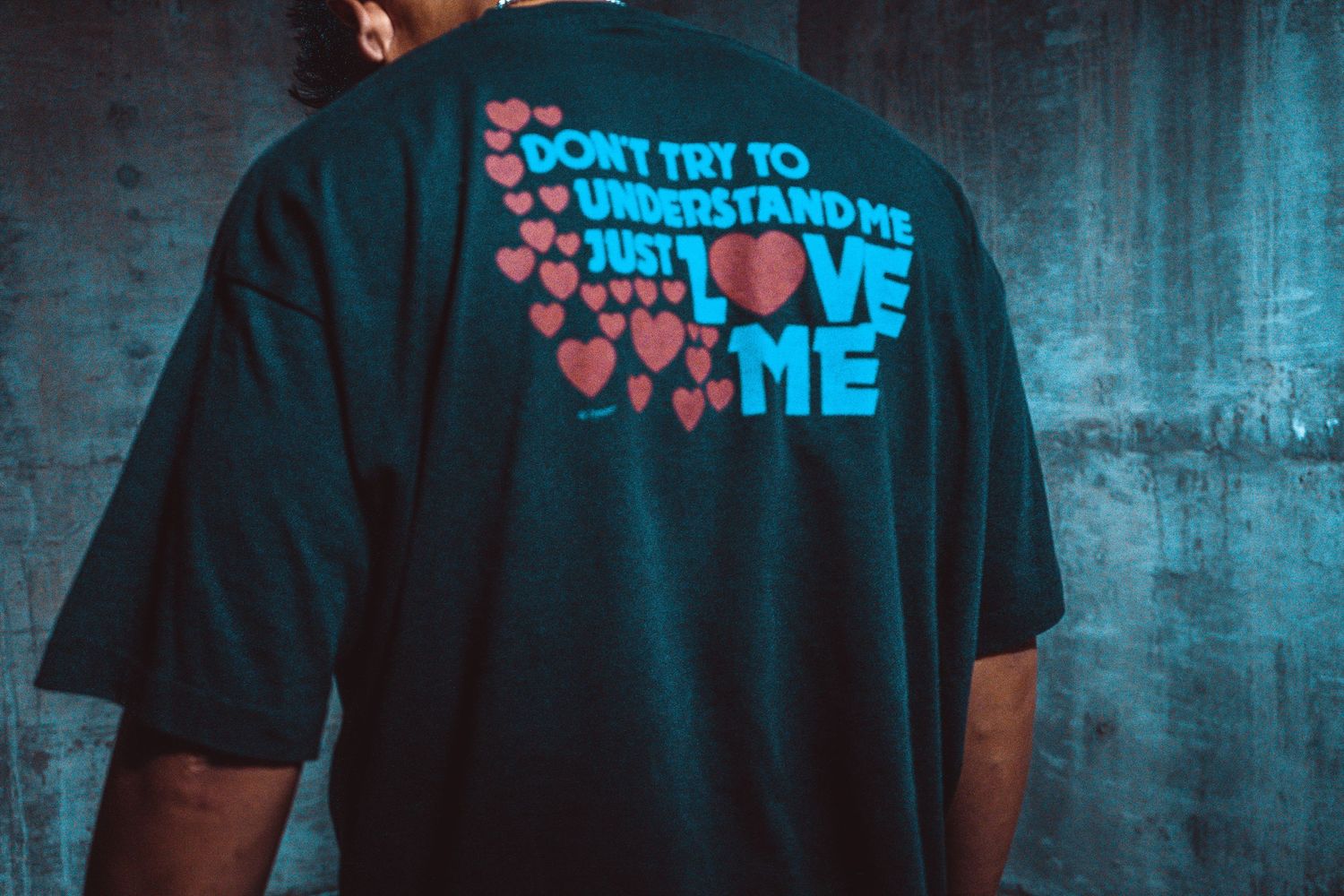 T-shirt with text design photographed in blue atmospheric lighting.