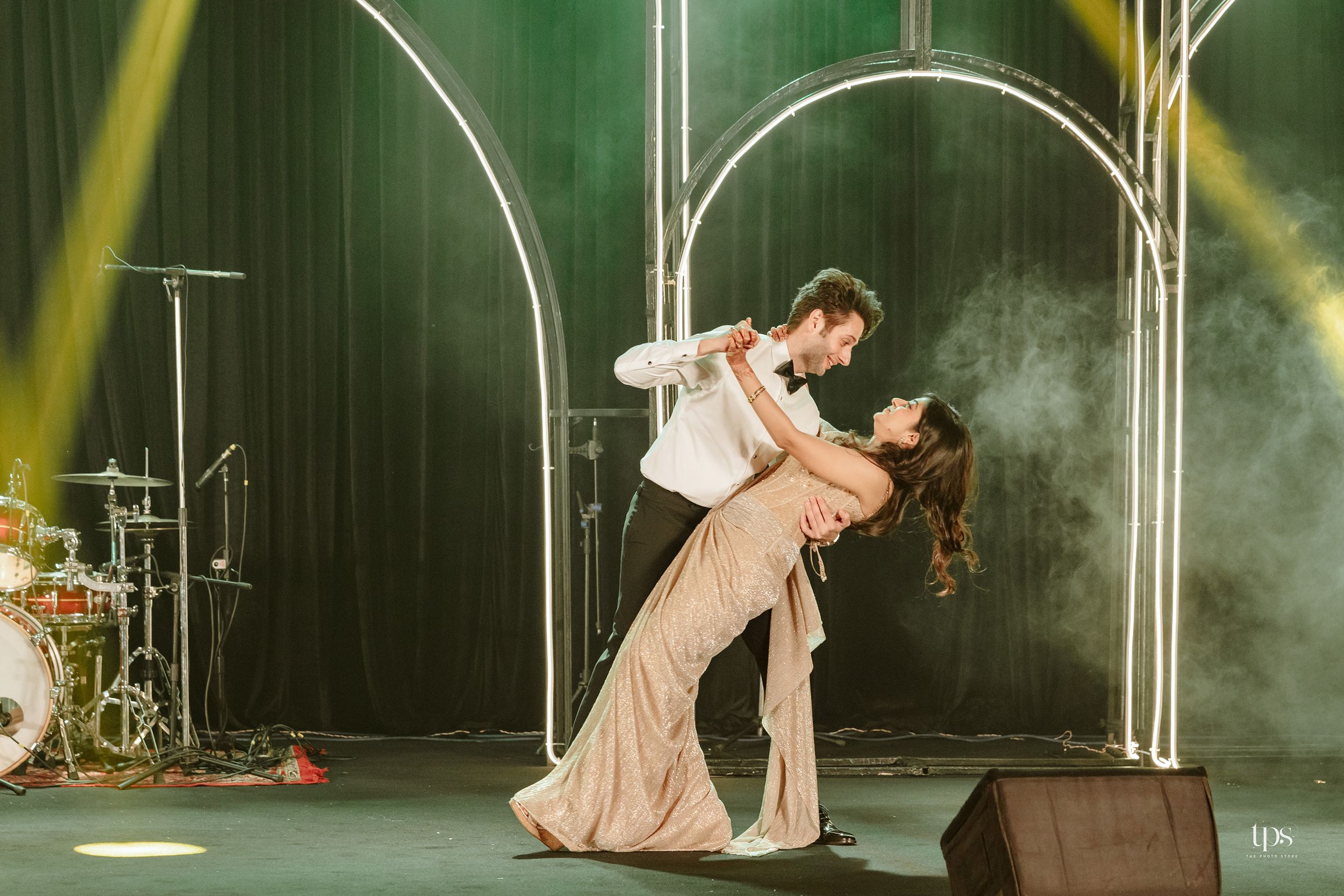 Artistic dance performance with dramatic lighting & smoke effects, theatrically captured by a professional wedding photographer in Mumbai.
