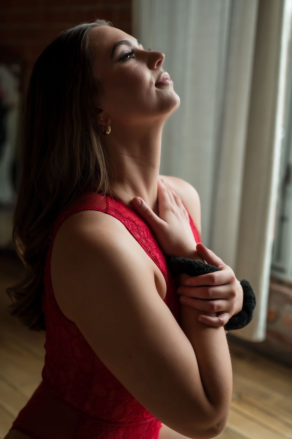 A dramatic photo series shows a person in red against a window, tilting their head back expressively.