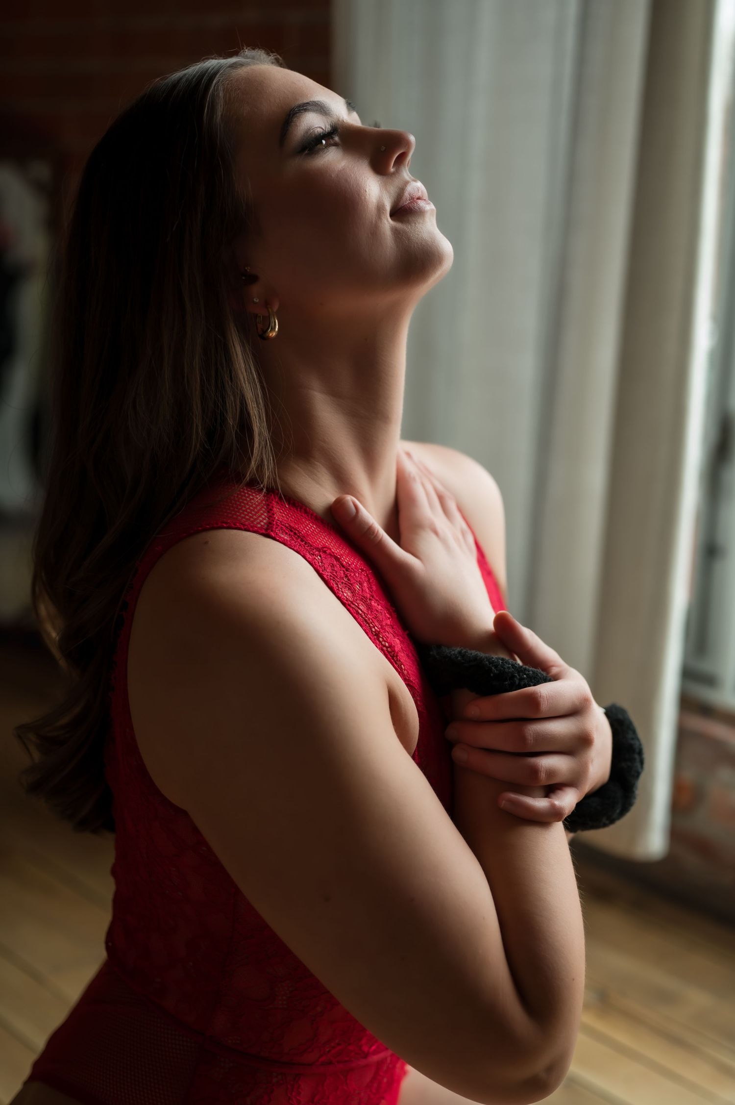A dramatic photo series shows a person in red against a window, tilting their head back expressively.