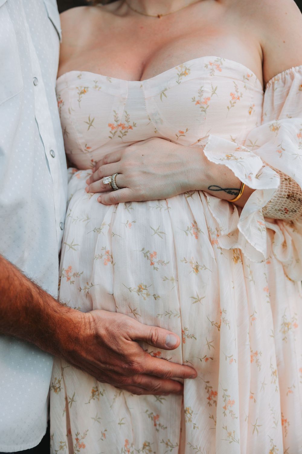 A series of intimate close-up photos showing hands tenderly cradling a pregnant belly wearing a delicate floral dress.