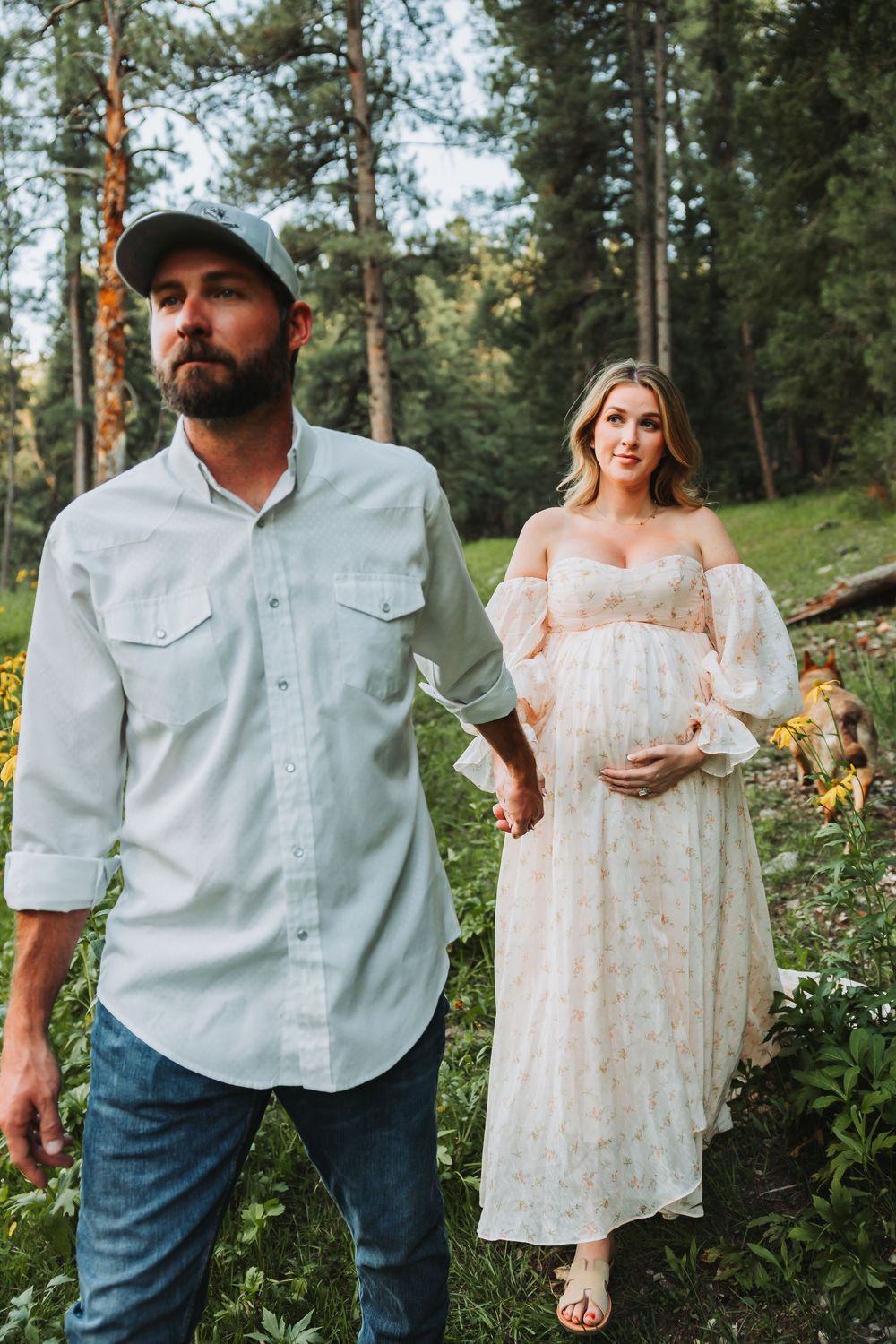 A rustic outdoor couple's photoshoot series featuring light blue shirt and white floral dress among pine trees.