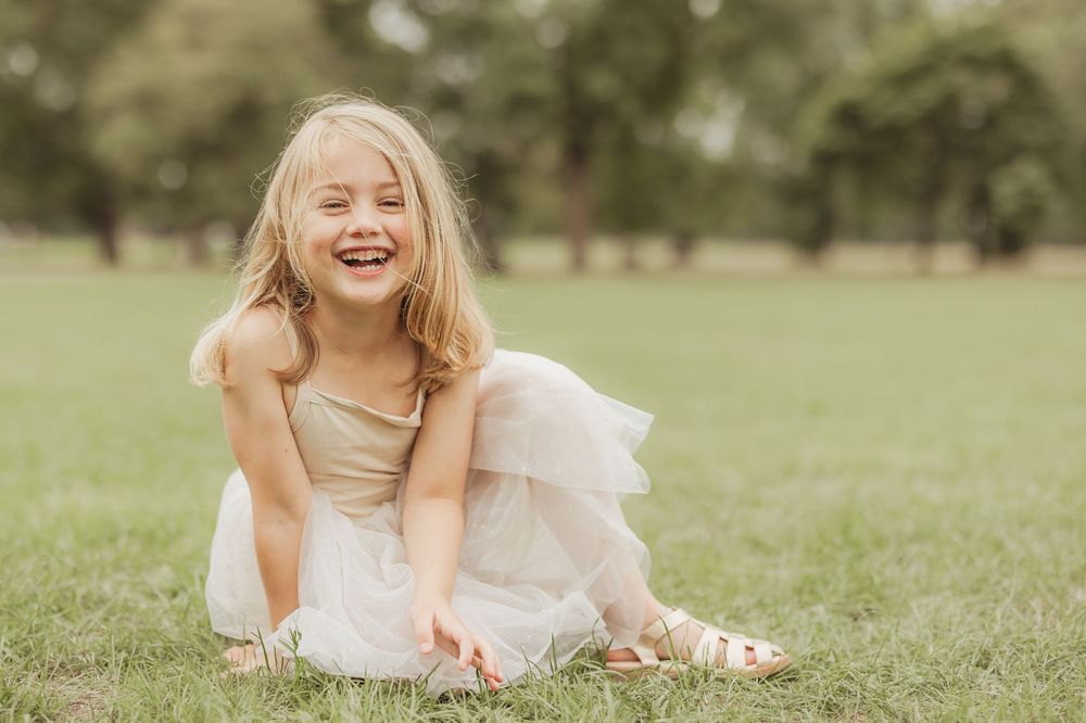 Playful moments captured in a grassy field on a sunny day.