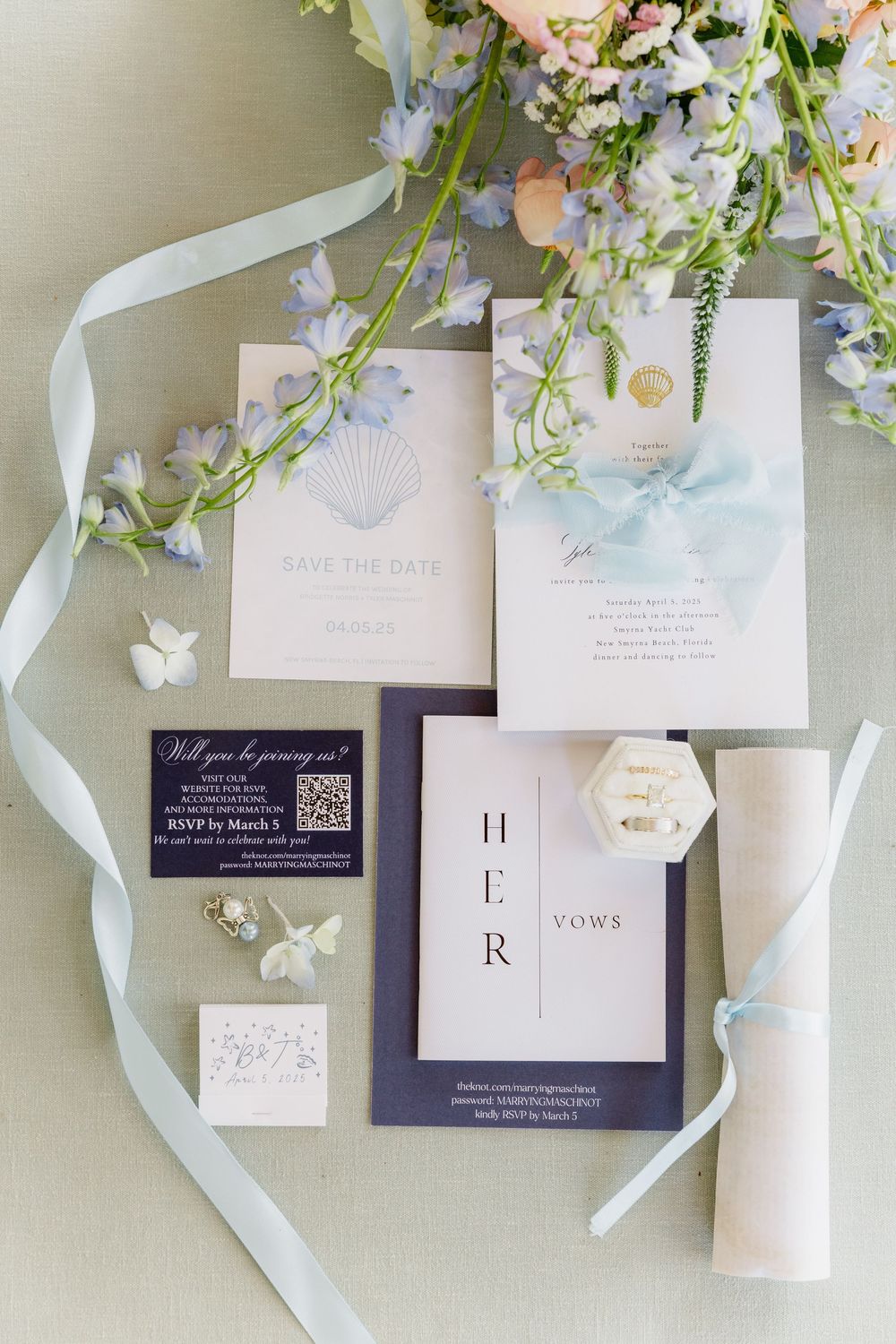 Elegant wedding invitation suite in navy and blush with floral details and silk ribbon accents.