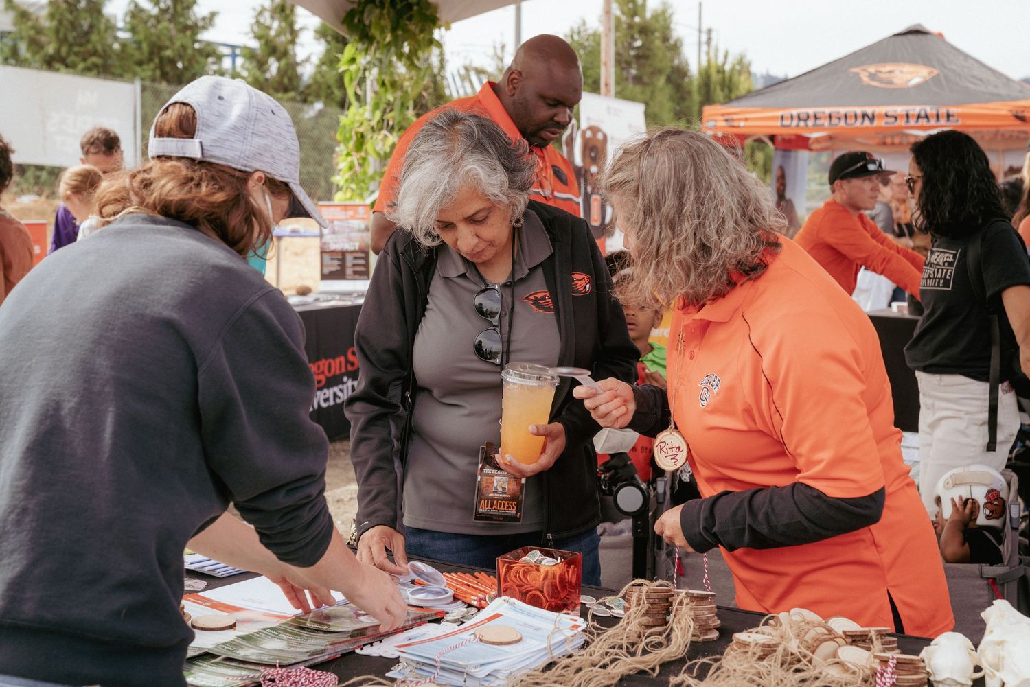 Team engaging visitors at an outdoor booth — commercial brand photography, Portland & Vancouver.