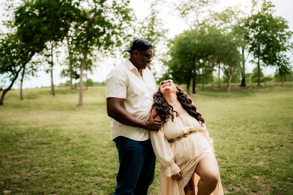 Dancing couple shares tender moments in a scenic park setting during a photo session.