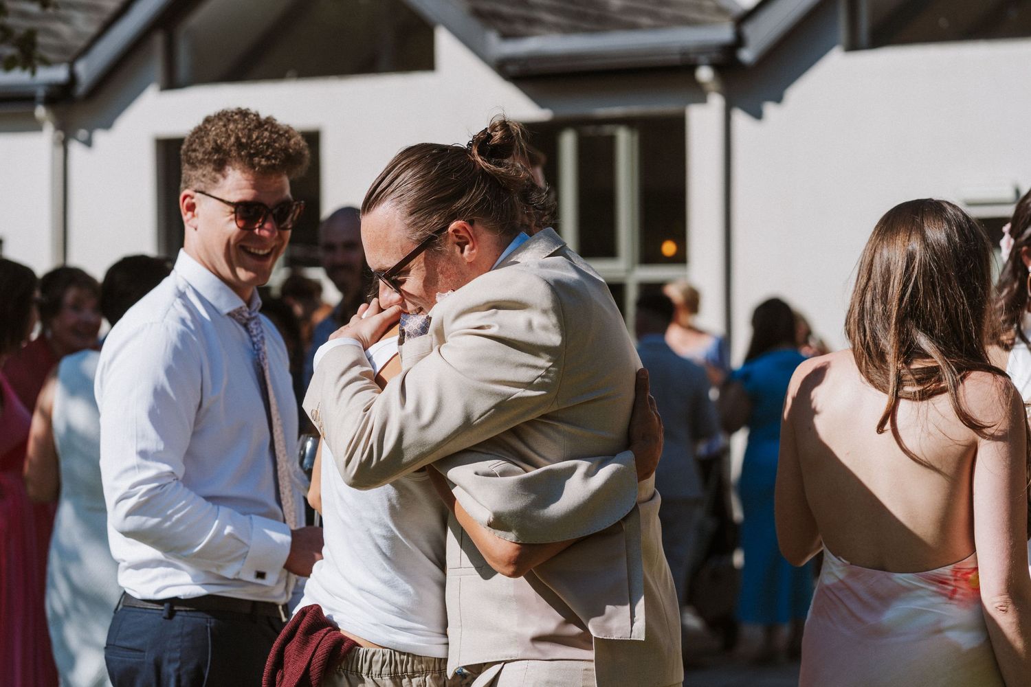 A collection of candid moments from a wedding reception showing people dancing and embracing on the dance floor.