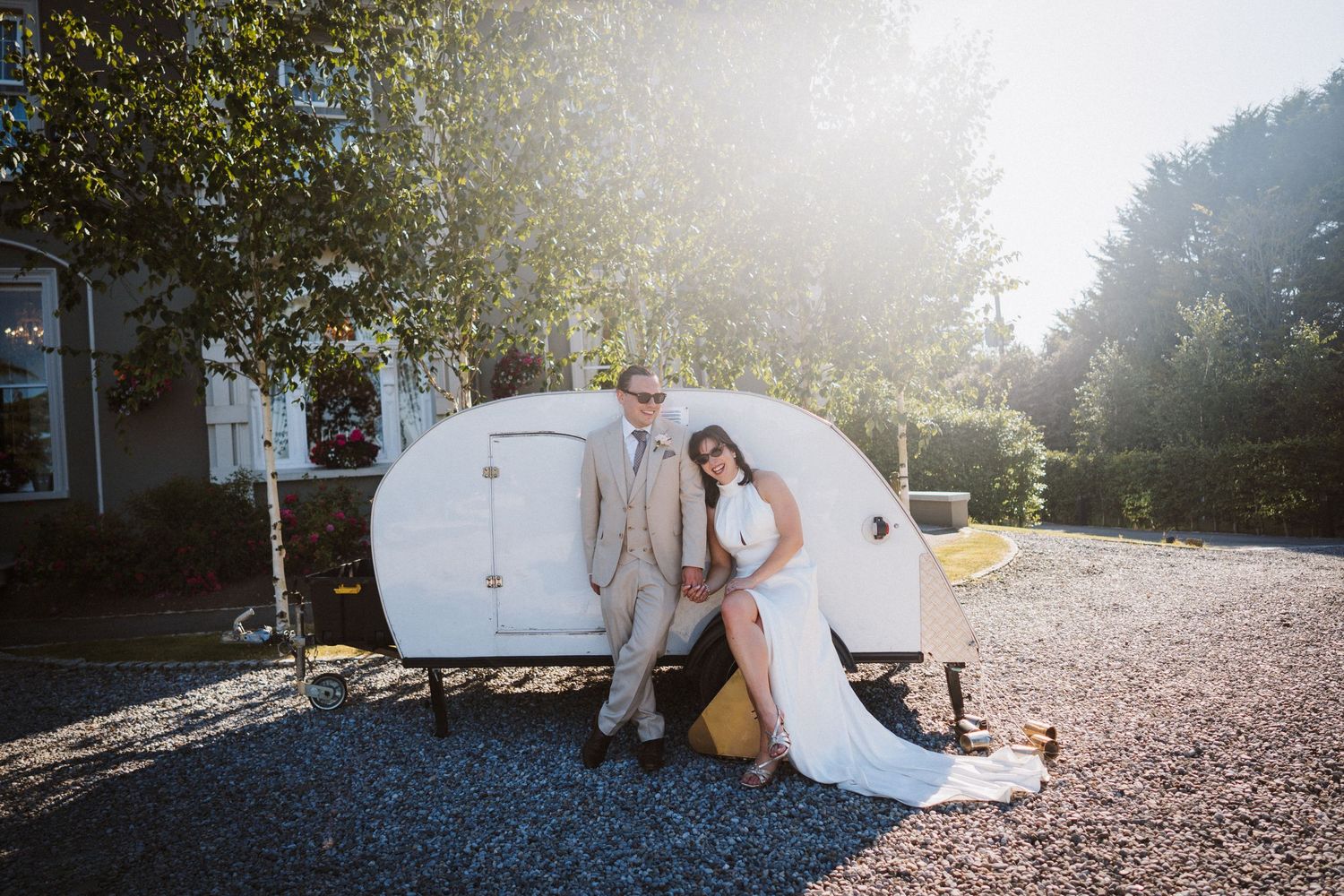 A romantic bride and groom share quiet moments together in an outdoor setting during their wedding photoshoot.