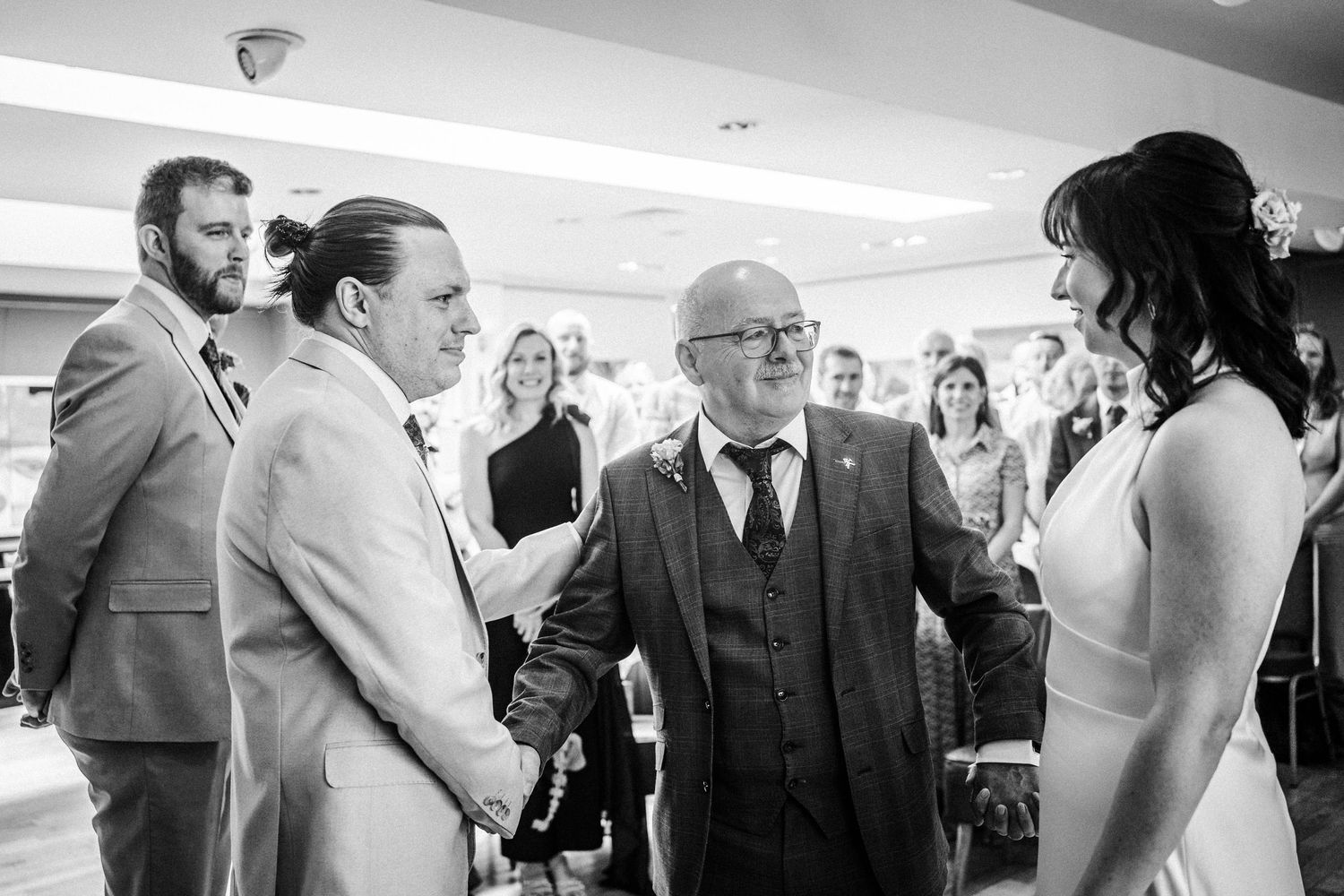 A series of candid black and white photos showing guests mingling at a formal event reception.