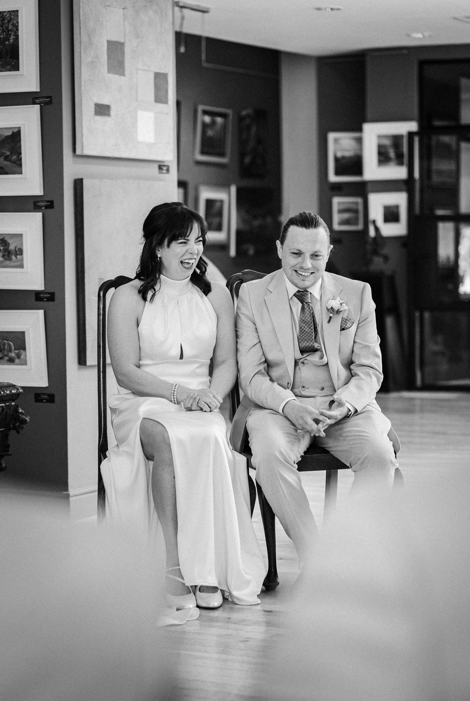 A series of black and white photos showing casual relaxed moments at a wedding venue.