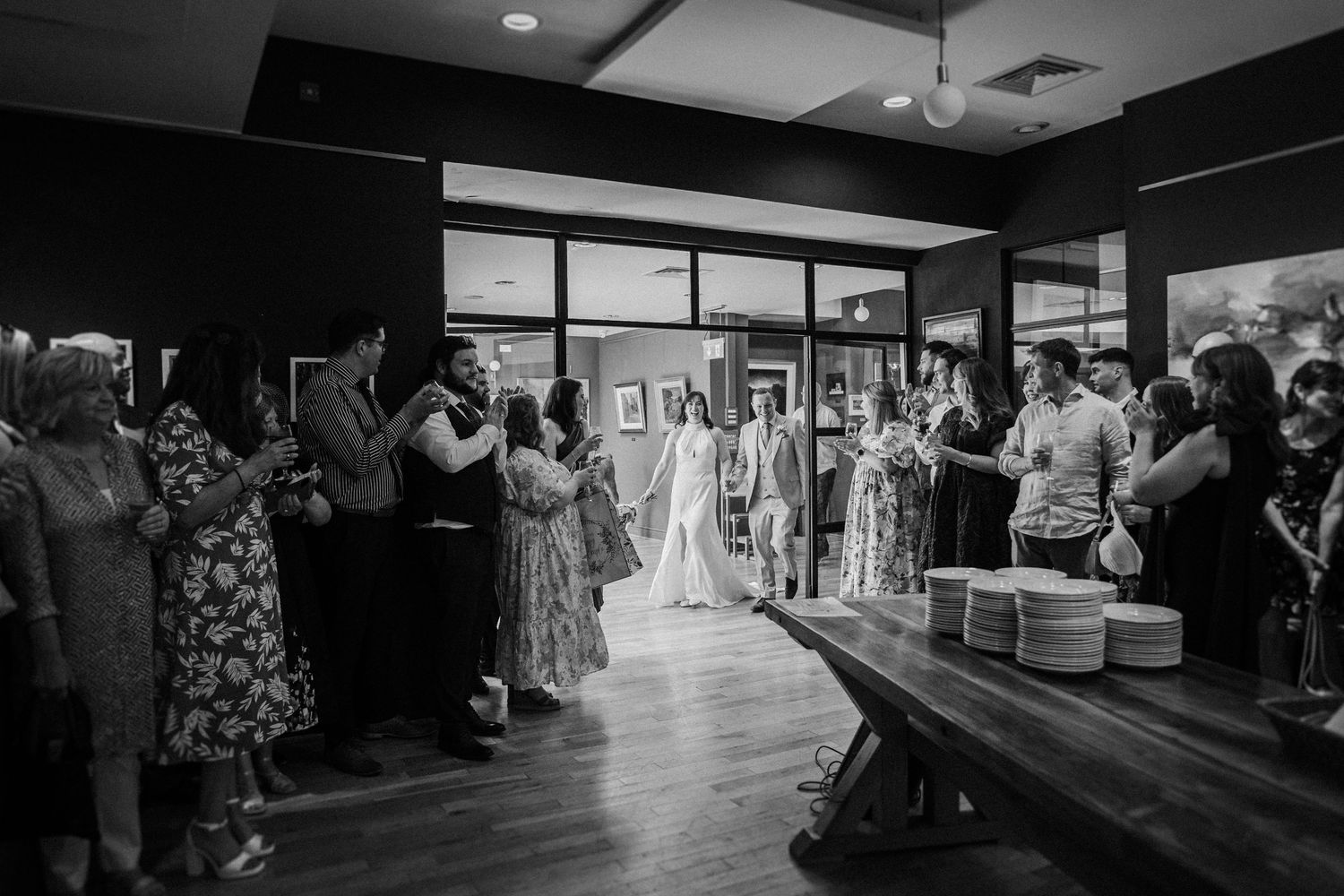 A black and white montage of several indoor event scenes in what appears to be a wedding venue.