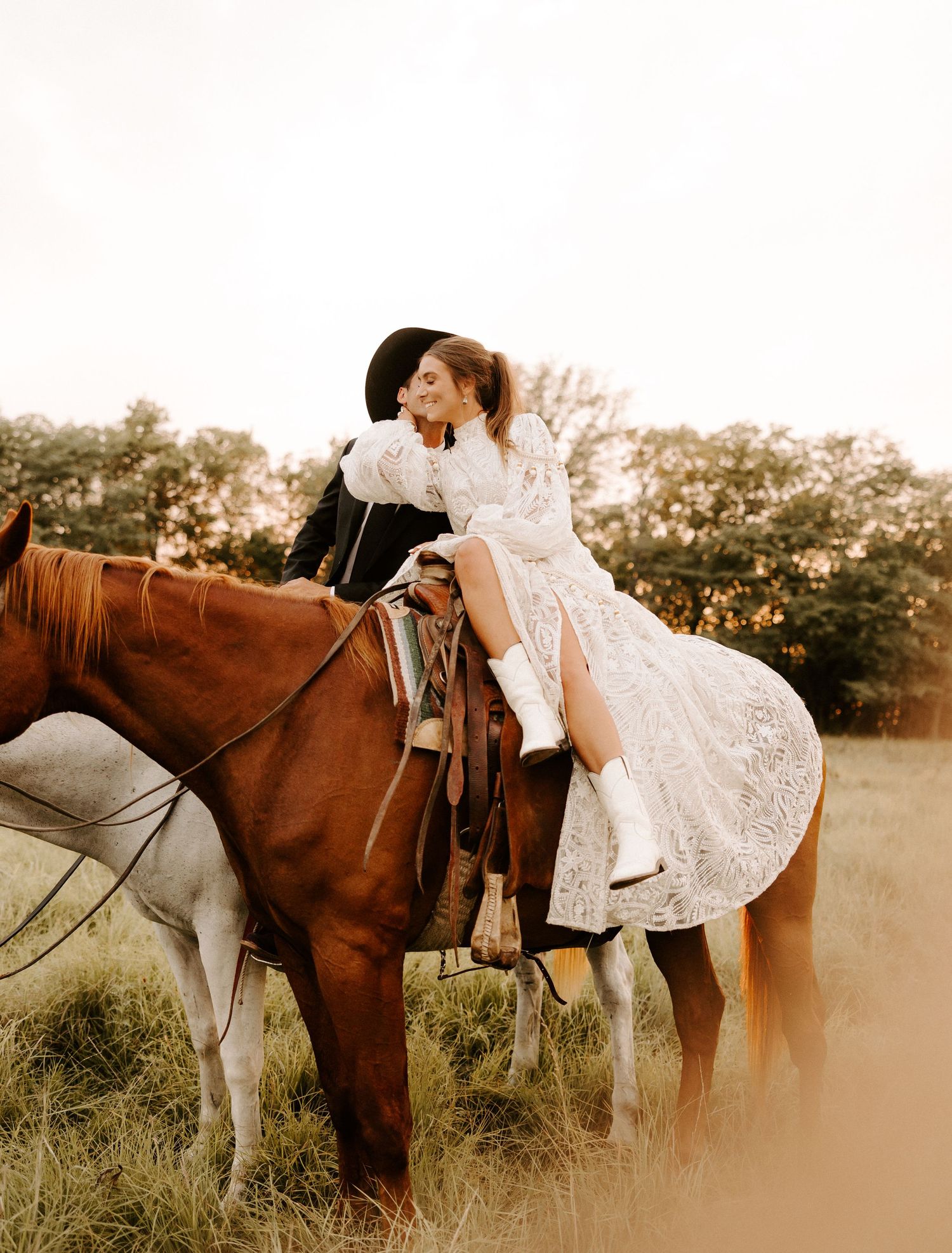 Romantic scene with horses in field at sunset showing white lace dress in Gallatin, TN.