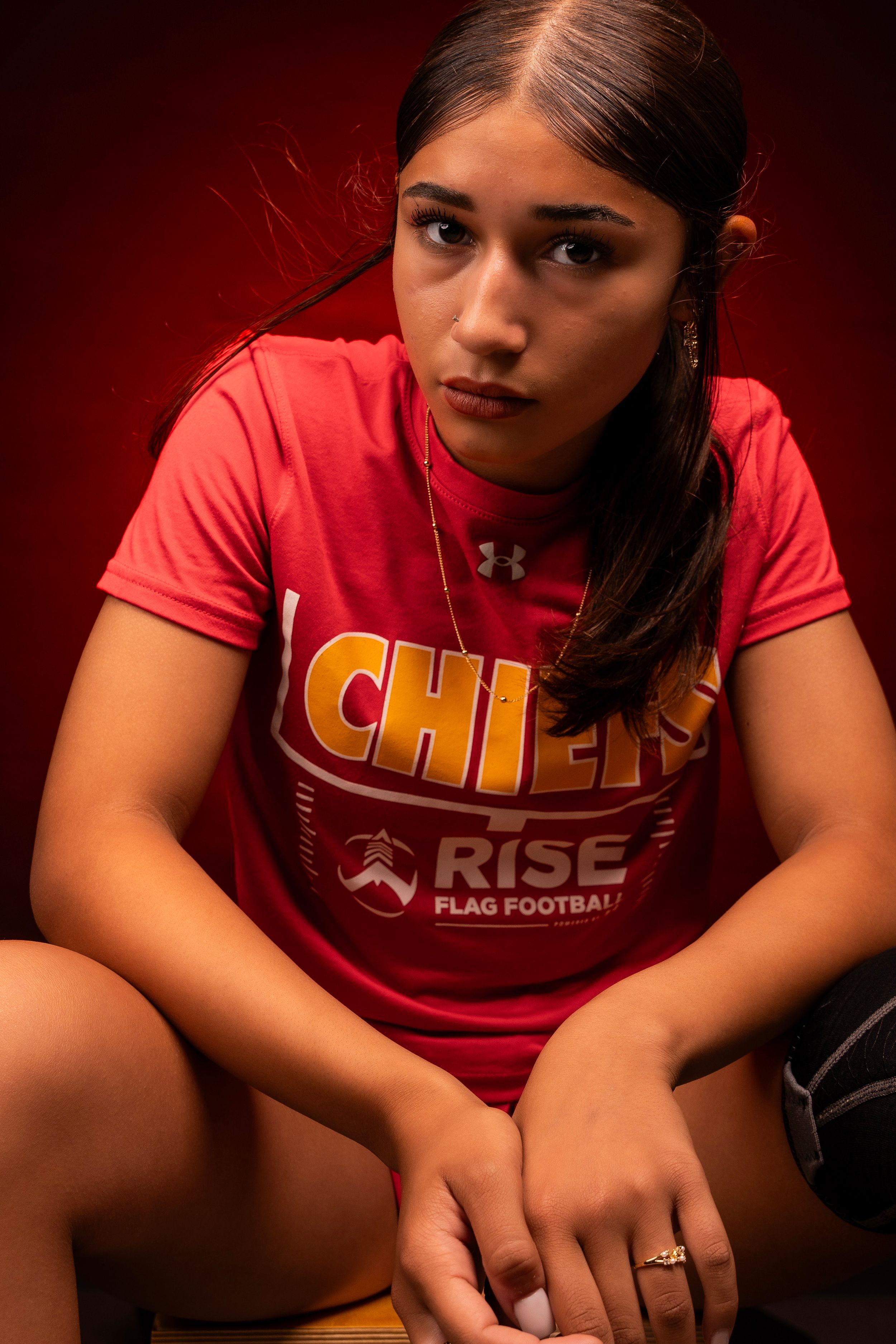 Close-up portrait series showing red and gold Chiefs uniform in moody lighting.