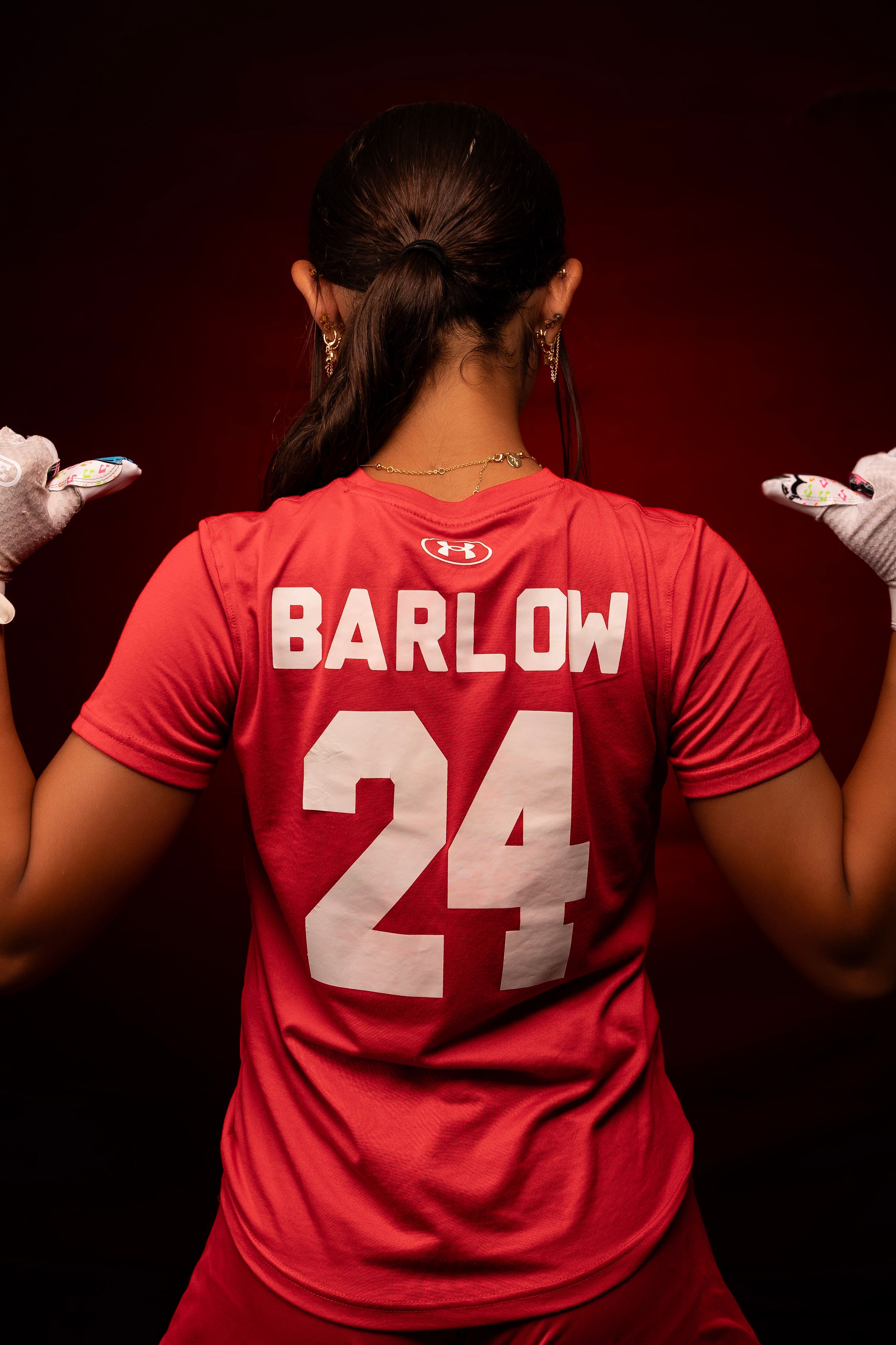 Back view of red sports jersey showing number 24 and Barlow name plate.