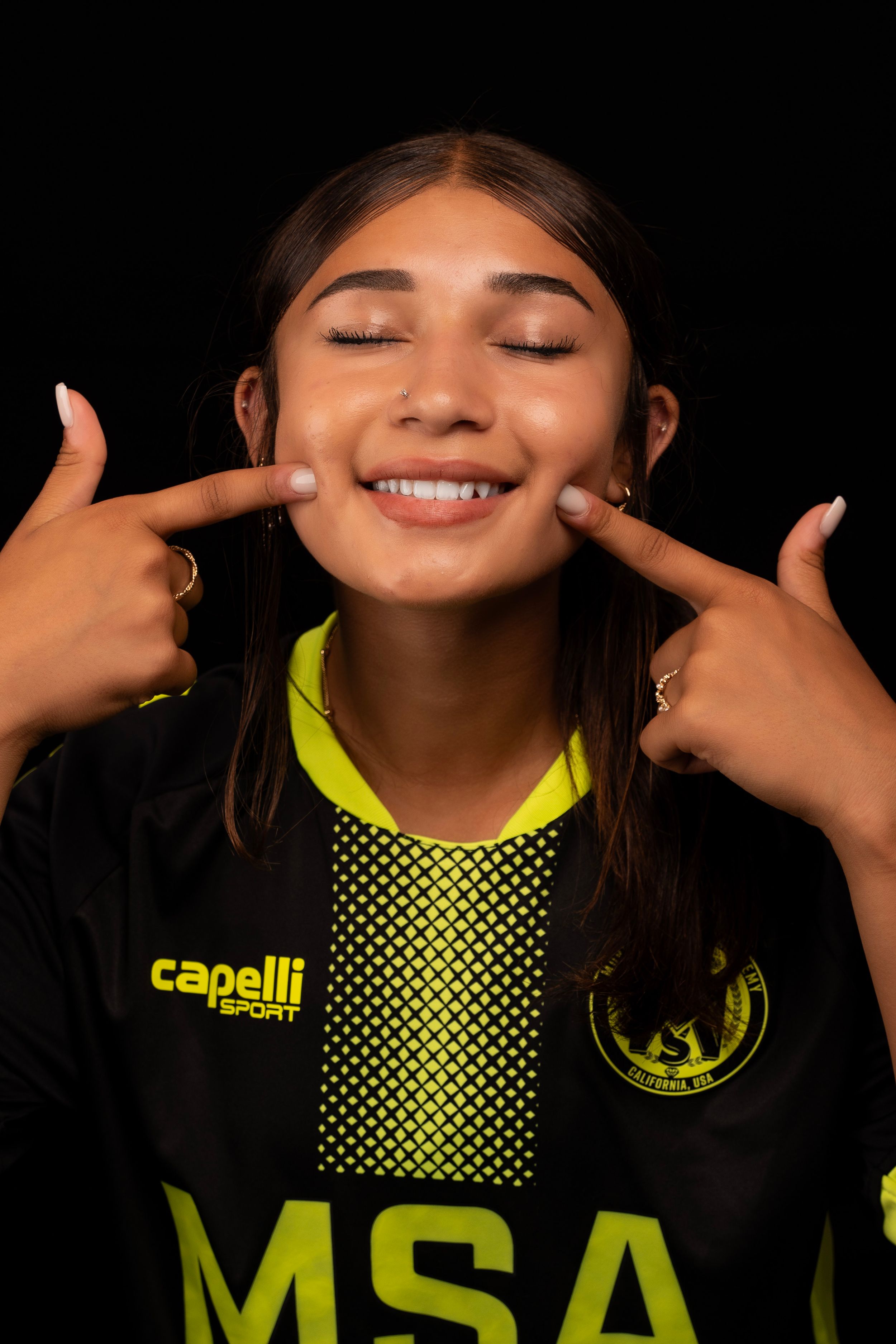 Athletic poses in black and neon yellow MSA uniform against dark backdrop.