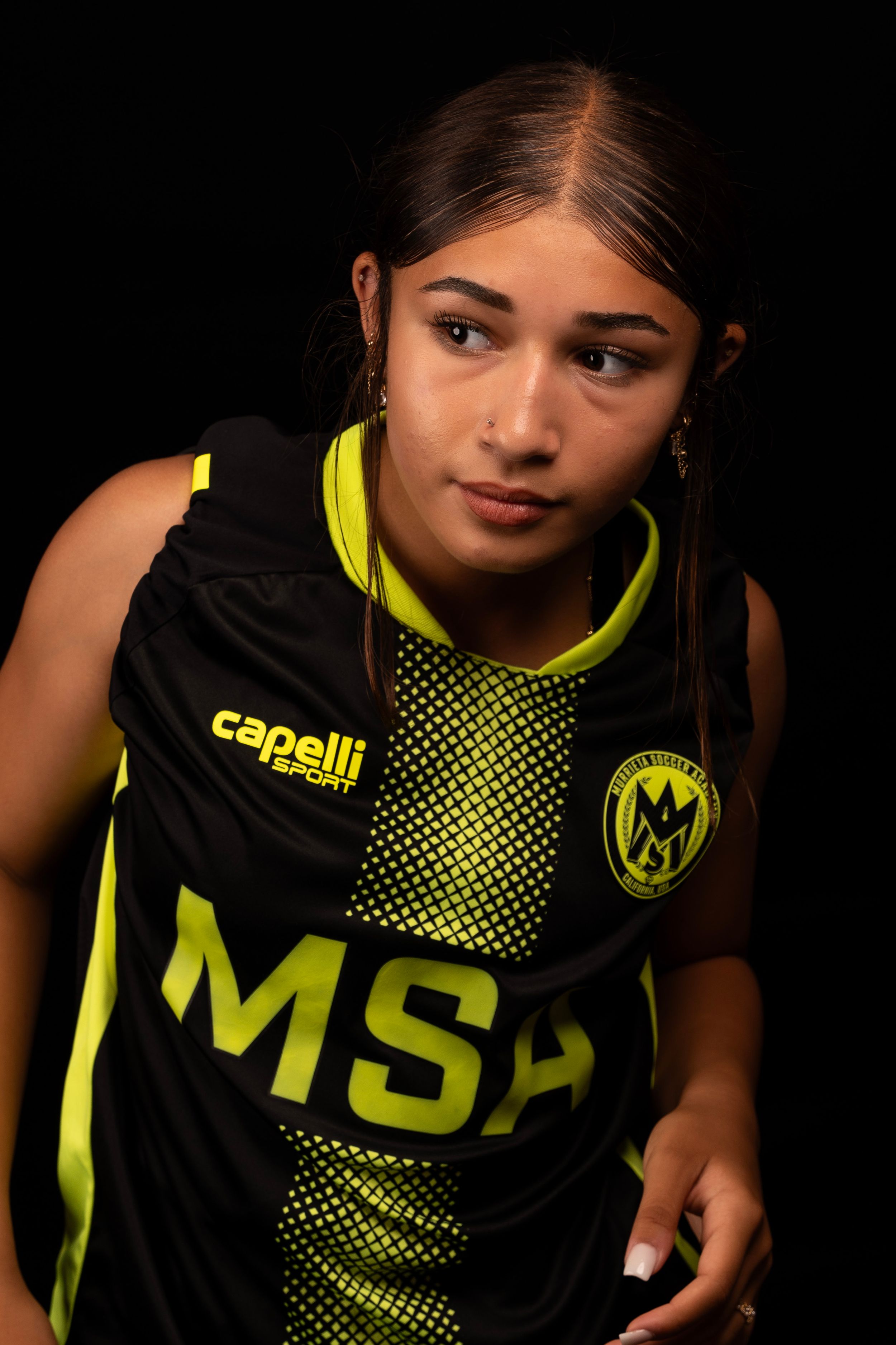 Sports portrait in black MSA jersey with neon yellow accents and checkerboard pattern.