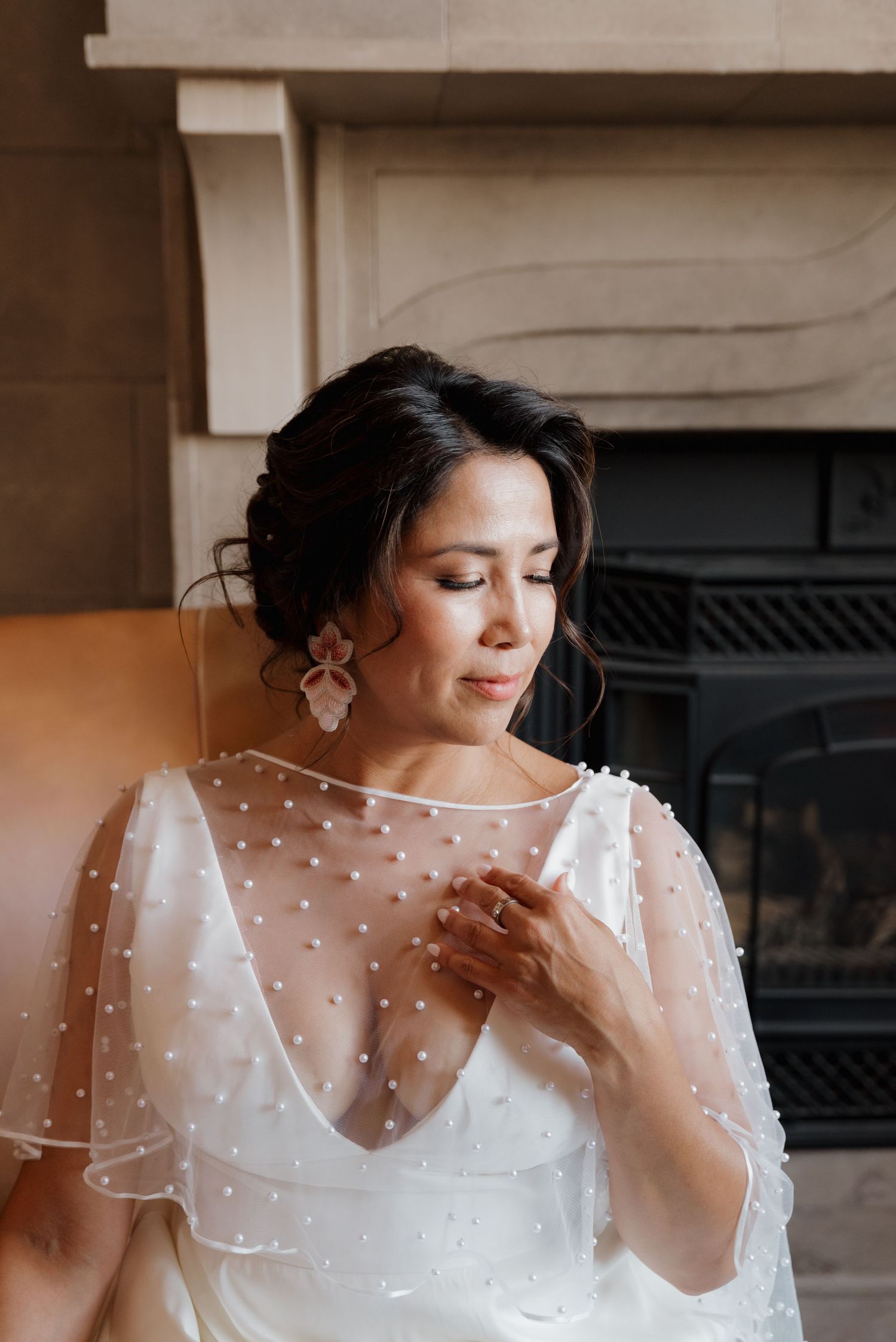 Person in white dotted sheer wedding dress with delicate details.