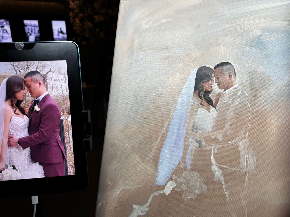 A wedding photograph displayed on a device screen next to its painted portrait version in soft romantic tones.