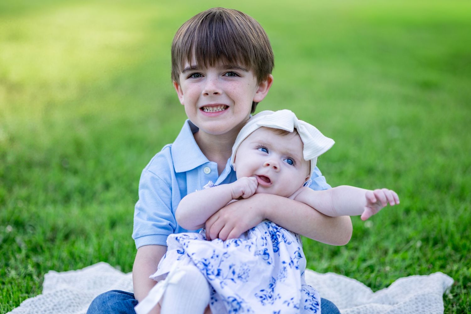 Central Illinois family photographer captures siblings sitting together during a photo session in in Springfield, IL