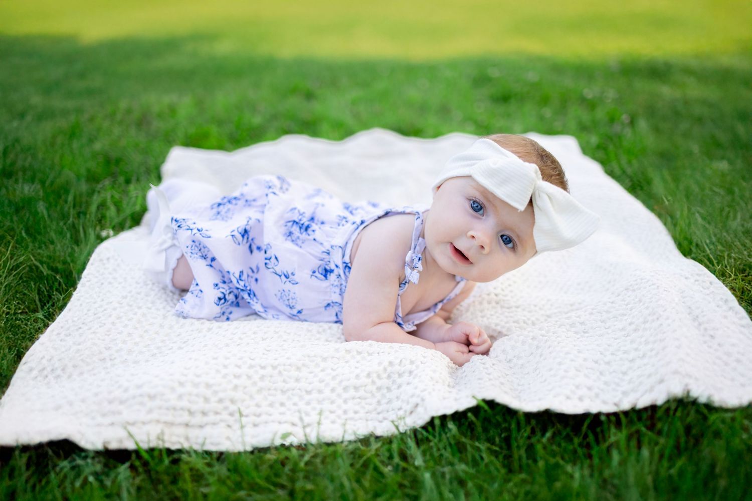 Central Illinois family photographer captures a baby laying on her belly during a photo session in Springfield, IL