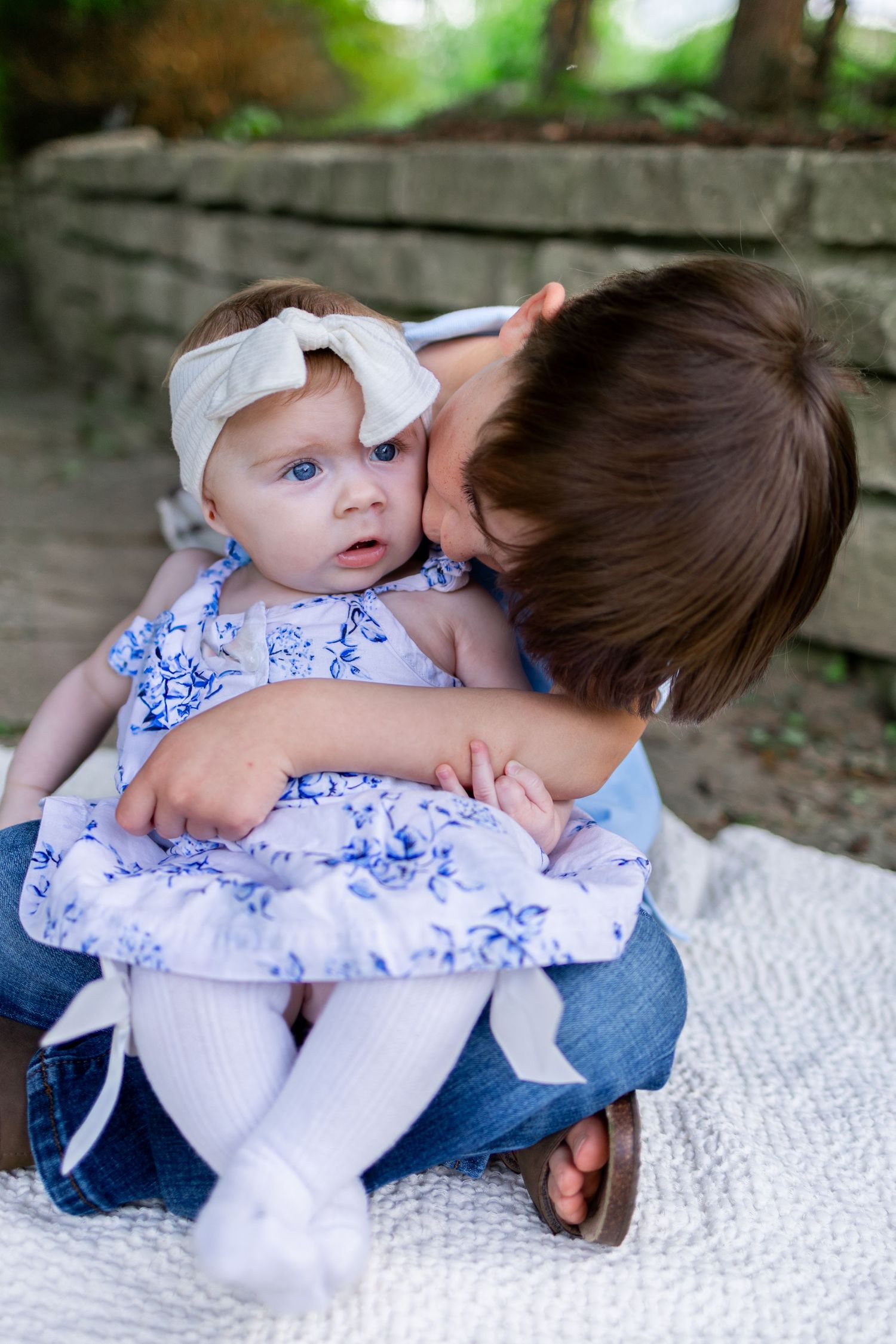 Central Illinois family photographer captures a brother kissing his sister's cheek during a photo session in Springfield, IL