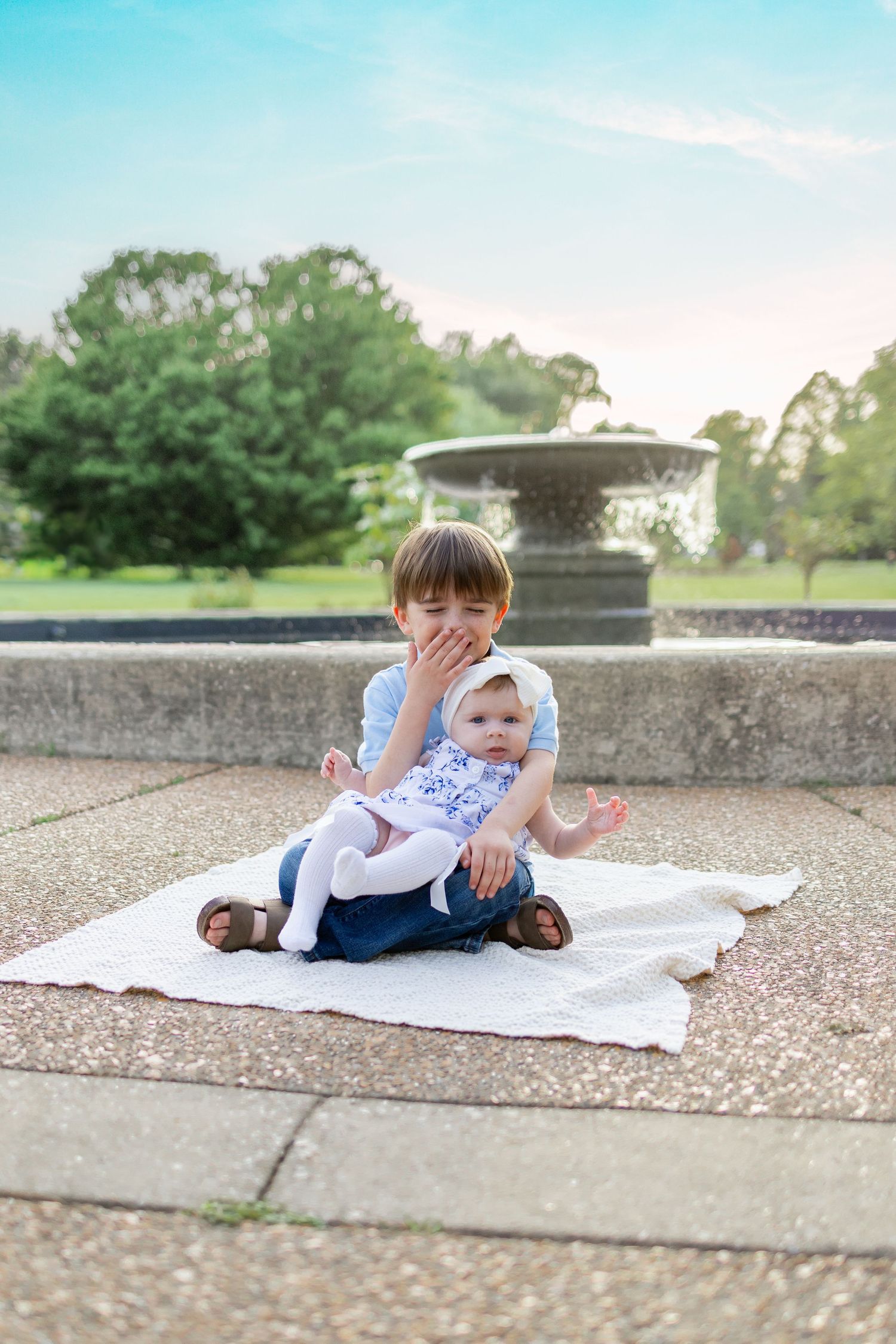 Central Illinois family photographer captures two siblings smiling and laughing together during a photo session in Springfield, IL