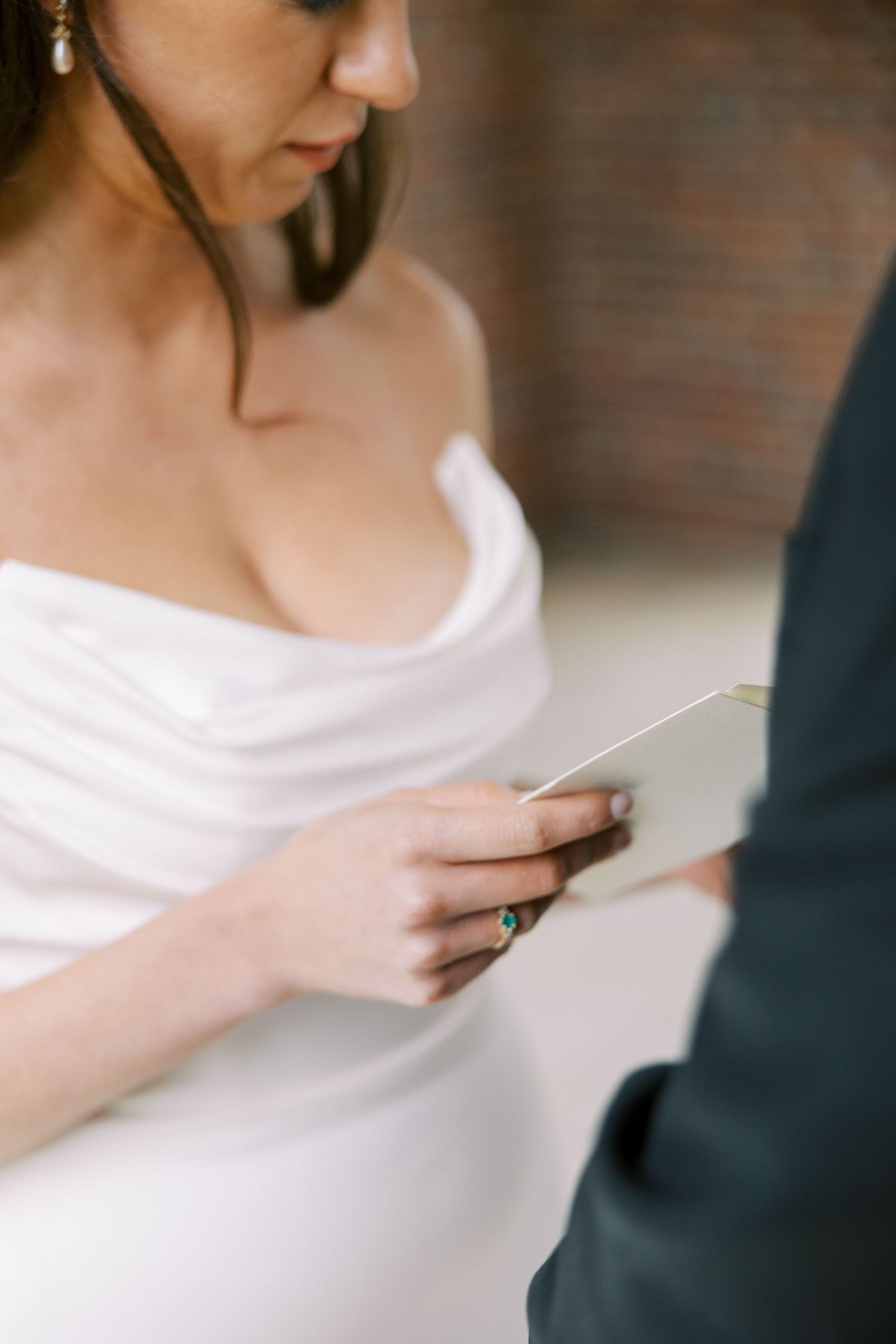 Black and white photo of couple reading vows during an intimate wedding ceremony in elegant bridal attire at Hall of Springs.
