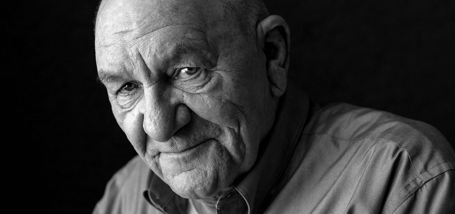 Dramatic black and white portrait of senior individual looking to the side.