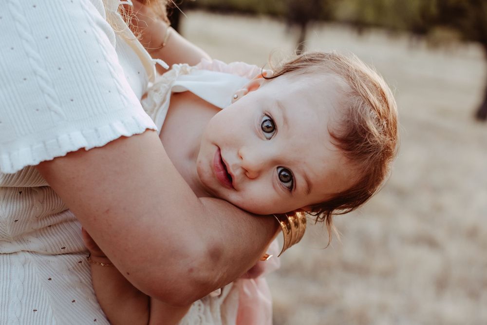 Natural light portrait session capturing innocent expressions and genuine moments.