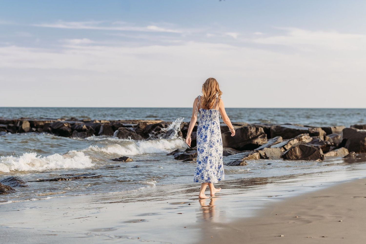 High school senior walking along the beach during a Jersey Shore senior photography session