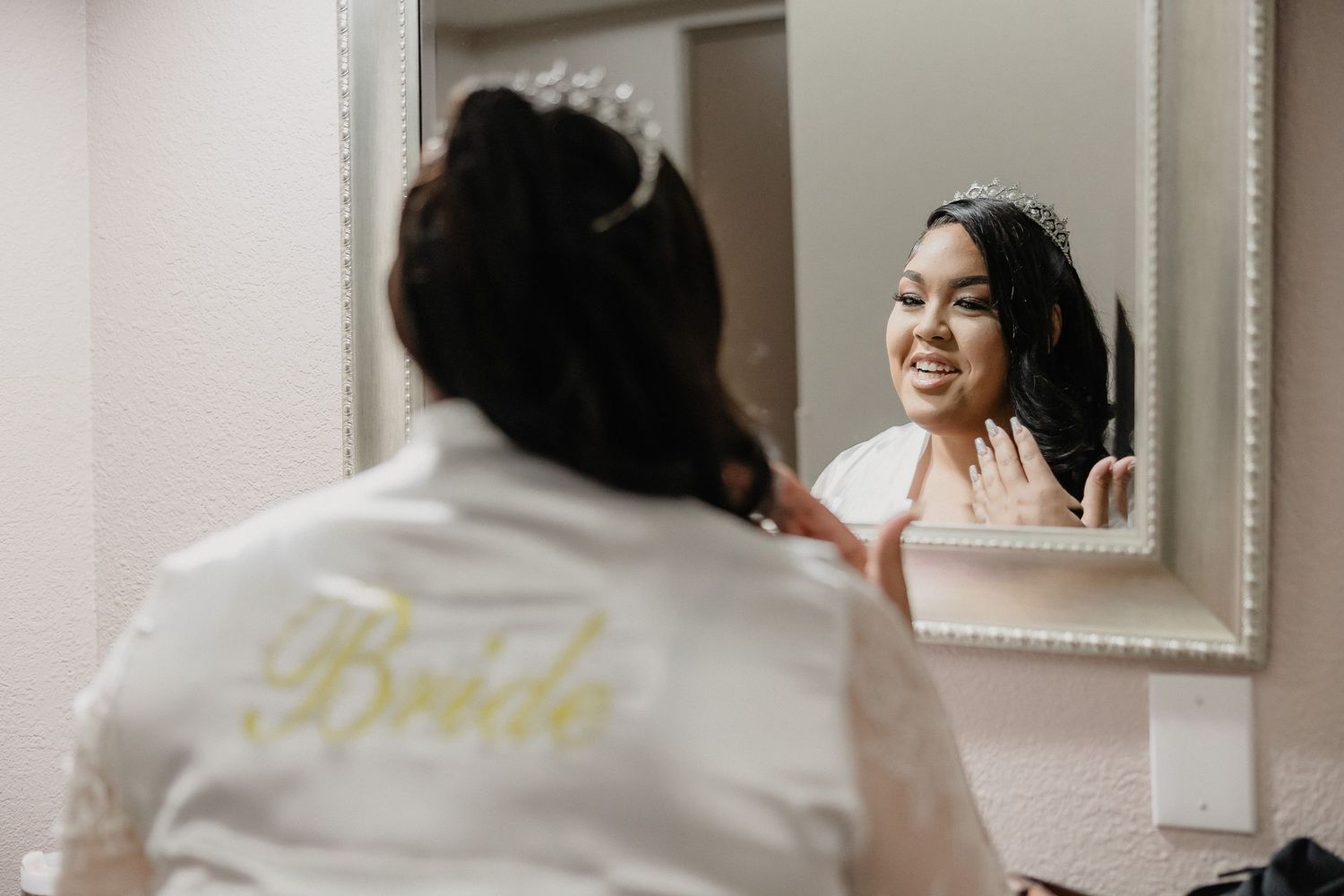 Bridal party getting ready in white robes while enjoying champagne in a bright, modern dressing room.