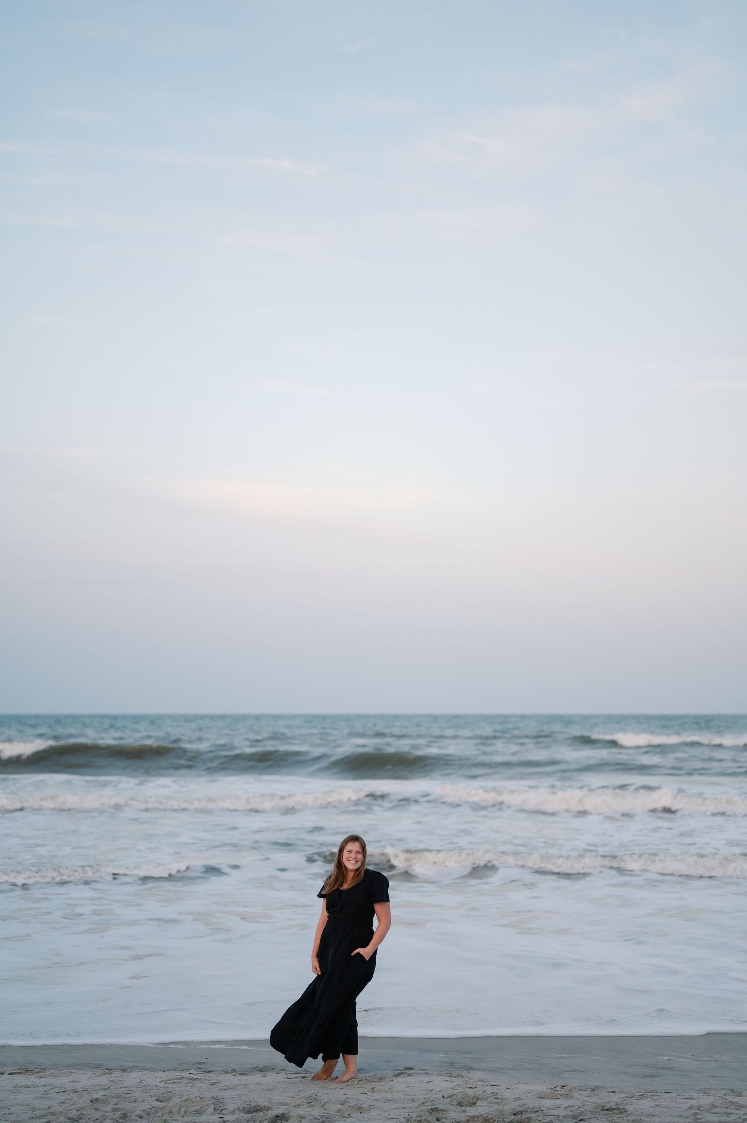 Portrait of Emily Barrett Photo, Southeast wedding photographer, smiling on Jacksonville Beach in Florida