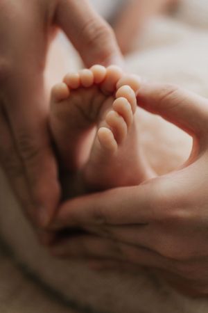 A series of close-up shots showing gentle hand massage techniques being performed on soft skin.