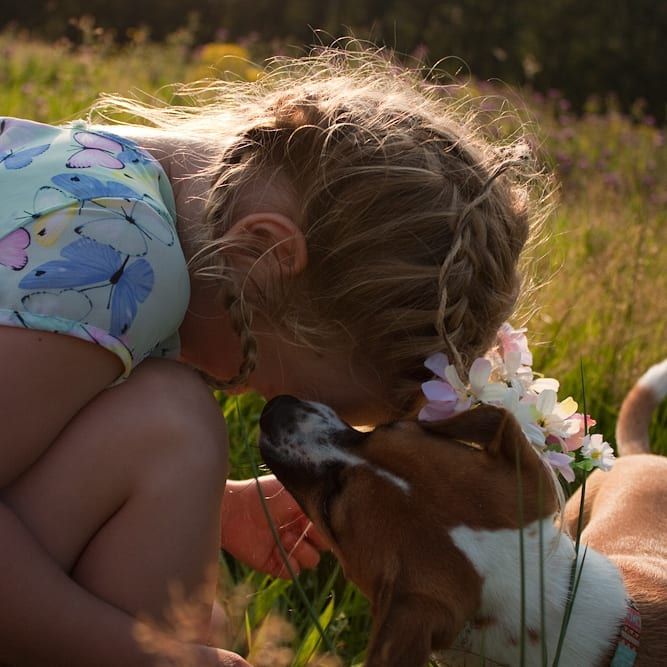 girl and puppy in field reddish vale